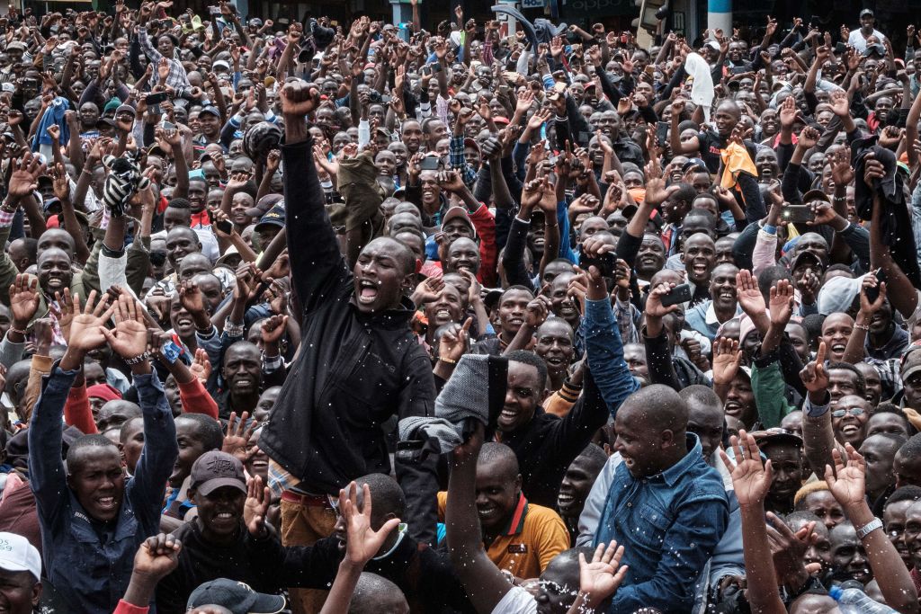 Kenyans watch a big screen on October 12, 2019, in Nairobi as they celebrate Kenya's Eliud Kipchoge victory. (YASUYOSHI CHIBA—AFP via Getty Images)