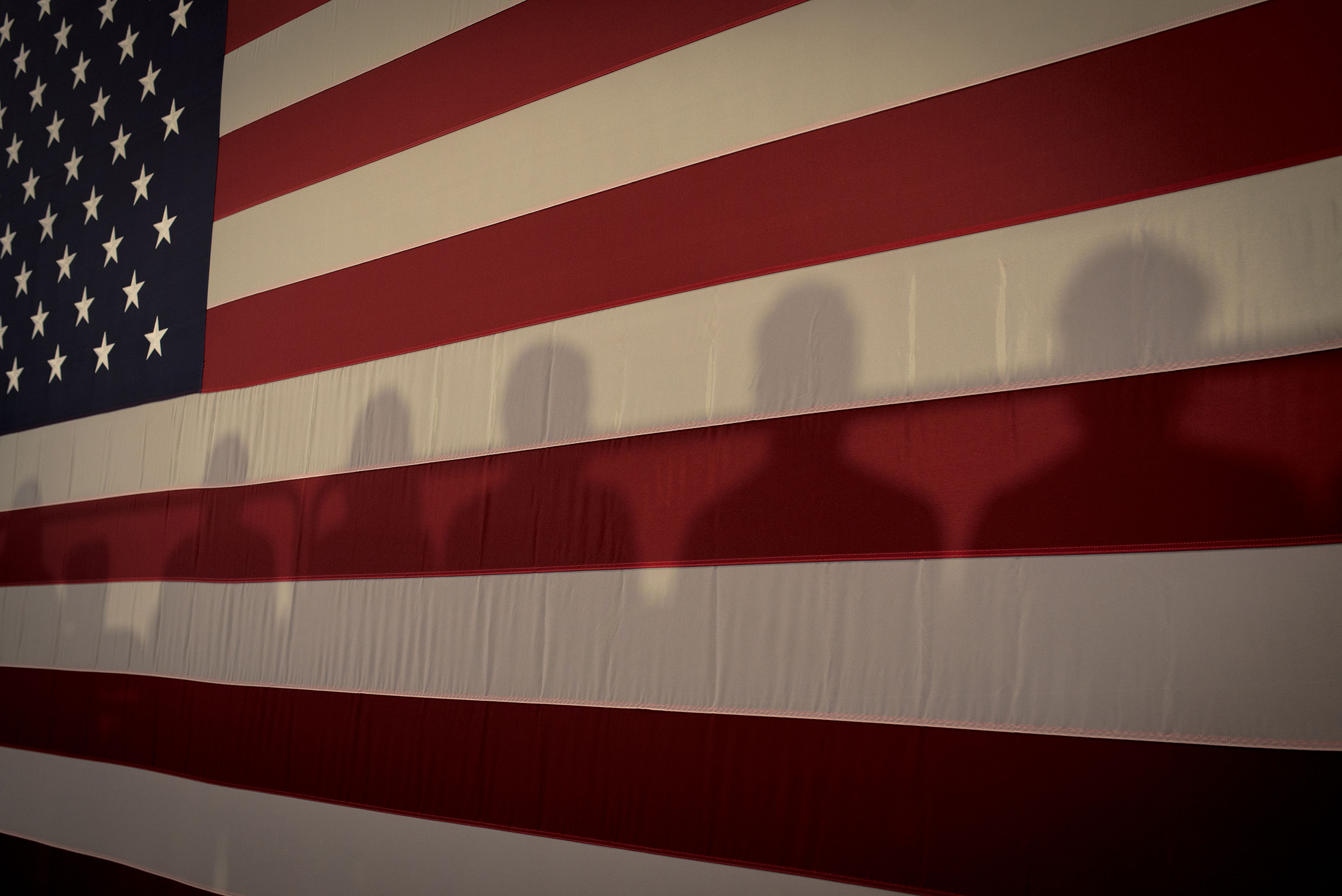 Shadows on an American Flag at Cedar Rapids Town Hall with Kamala Harris in Cedar Rapids, Iowa, Sept. 19, 2019. (September Dawn Bottoms for TIME)
