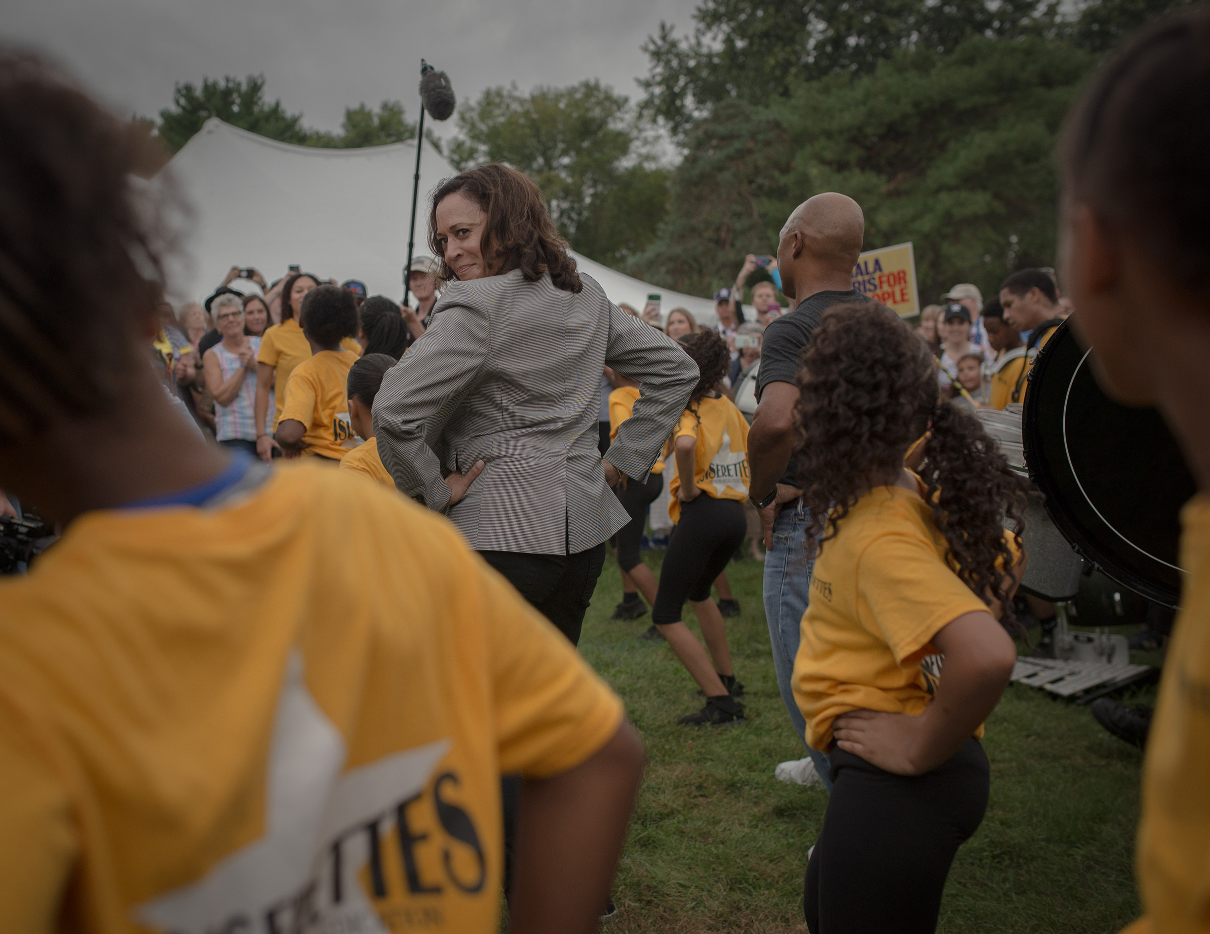 Harris takes a cue from a local drill team at the Des Moines Steakfry on Sept. 21, 2019. (September Dawn Bottoms for TIME)