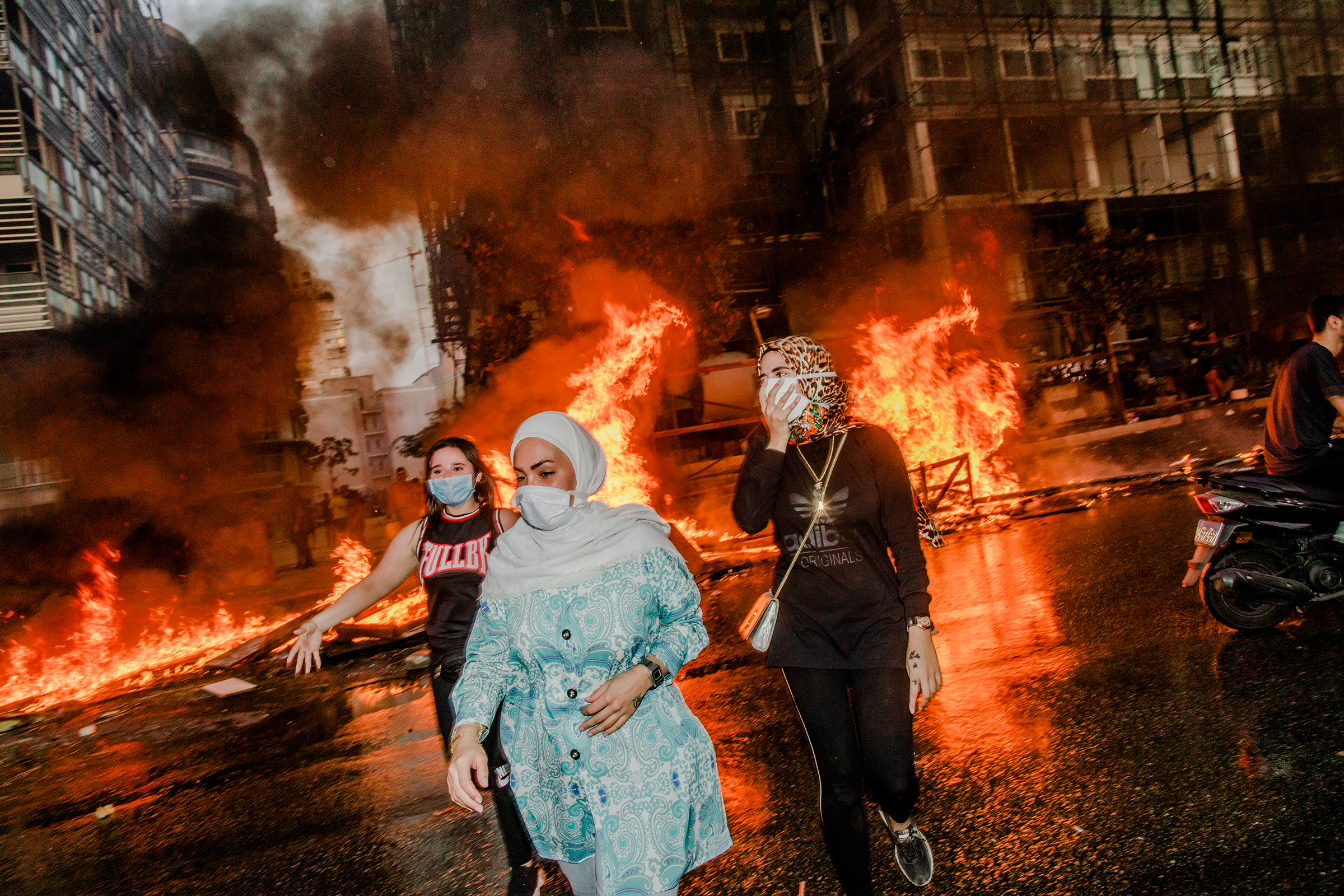 Nour, Nour and Farah attend a mass protest in Beirut on Oct. 18, 2019. (Myriam Boulos)