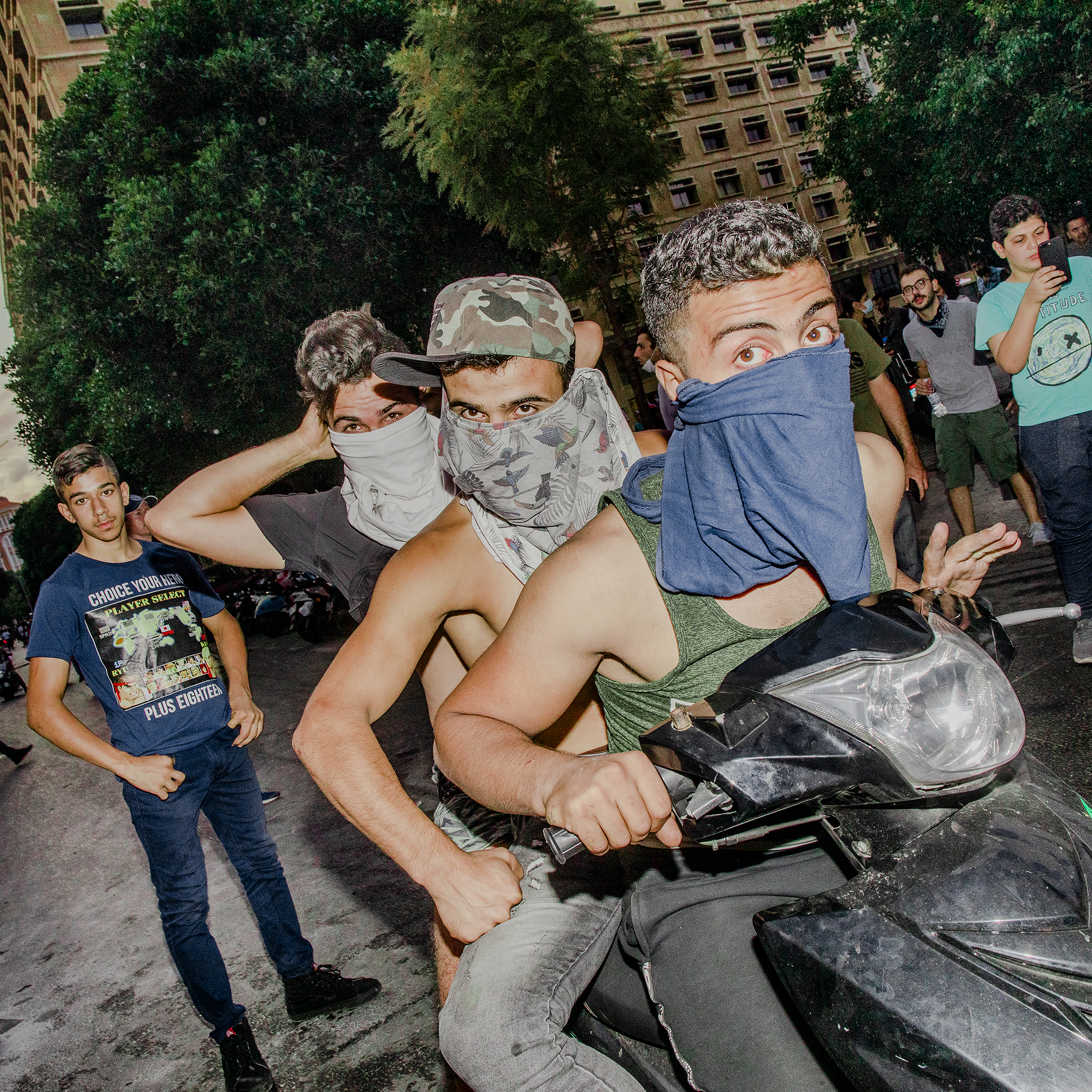 Young men on a motorcycle at a mass protest in Beirut on Oct. 18, 2019. (Myriam Boulos)