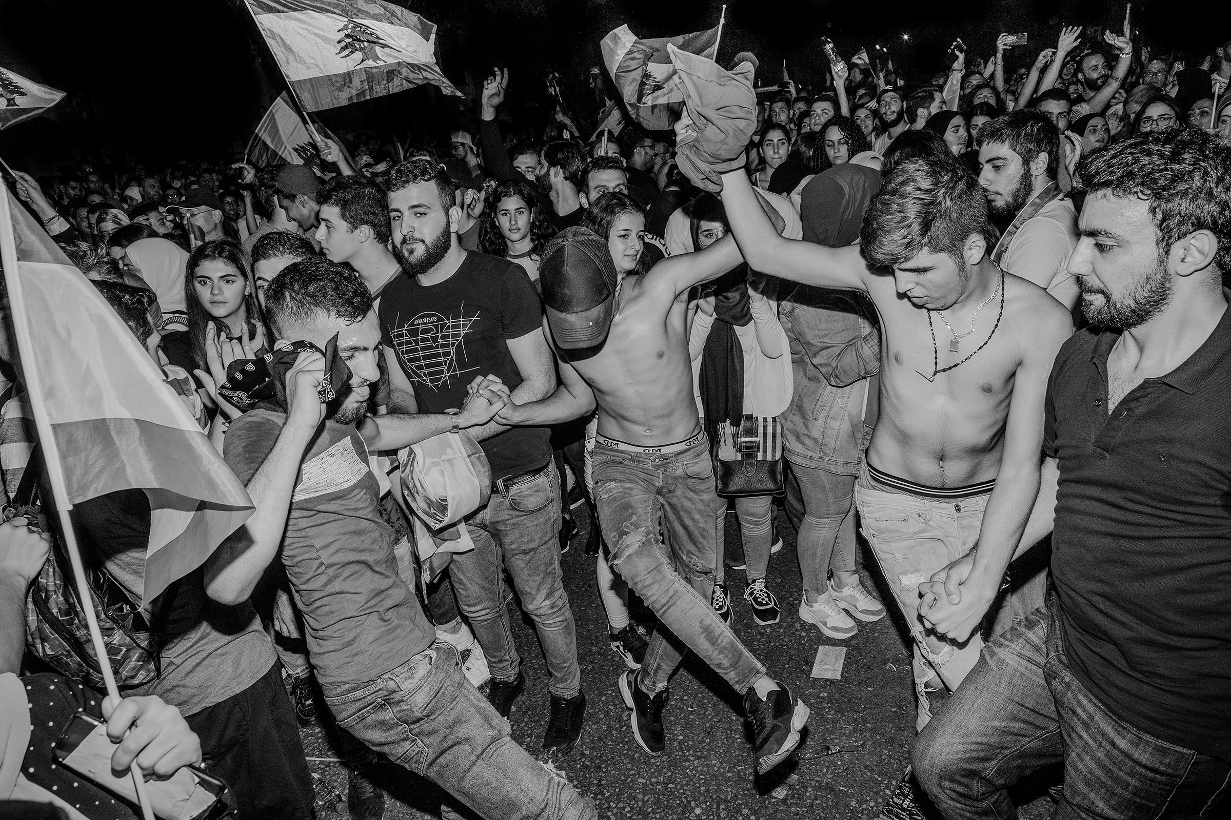 Men dance at a protest in Beirut on Oct. 20, 2019. (Myriam Boulos)