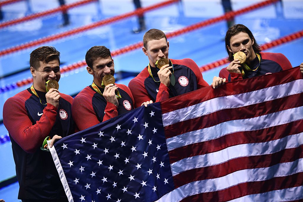 Team USA's gold medallists Ryan Murphy, Cody Miller, Michael Phelps, Nathan Adrian pose during the podium ceremony of the Men's swimming 4 x 100m Medley Relay Final at the Rio 2016 Olympic Games at the Olympic Aquatics Stadium in Rio de Janeiro on August 13, 2016. (Martin Bureau—AFP/Getty Images)