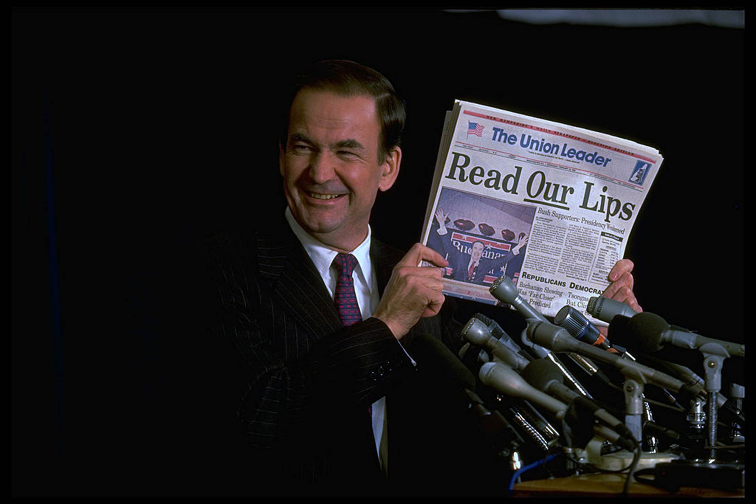 Conservative Republican presidential hopeful Pat Buchanan displaying The New Hampshire <i>Union Leader</i> headlining his triumph and threat to frontrunner and incumbent President George H.W. Bush on Feb. 1, 1992. (Steve Liss/The LIFE Images Collection—Getty Images)