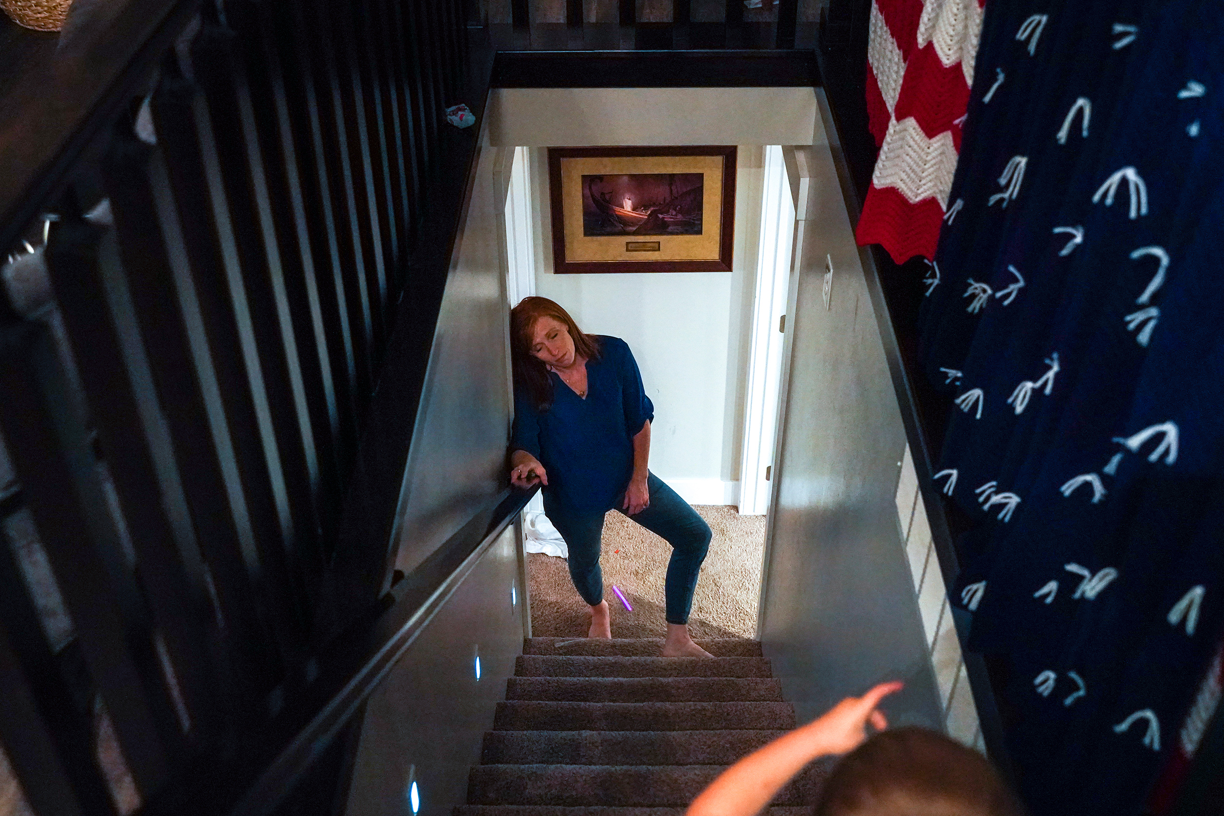 2019. North Ogden. Utah. USA. Jennie Taylor tries to get the kids to bed..  Her husband, Brent Taylor, was killed in Afghanistan the previous year during his fourth deployment. He left behind her and seven children.