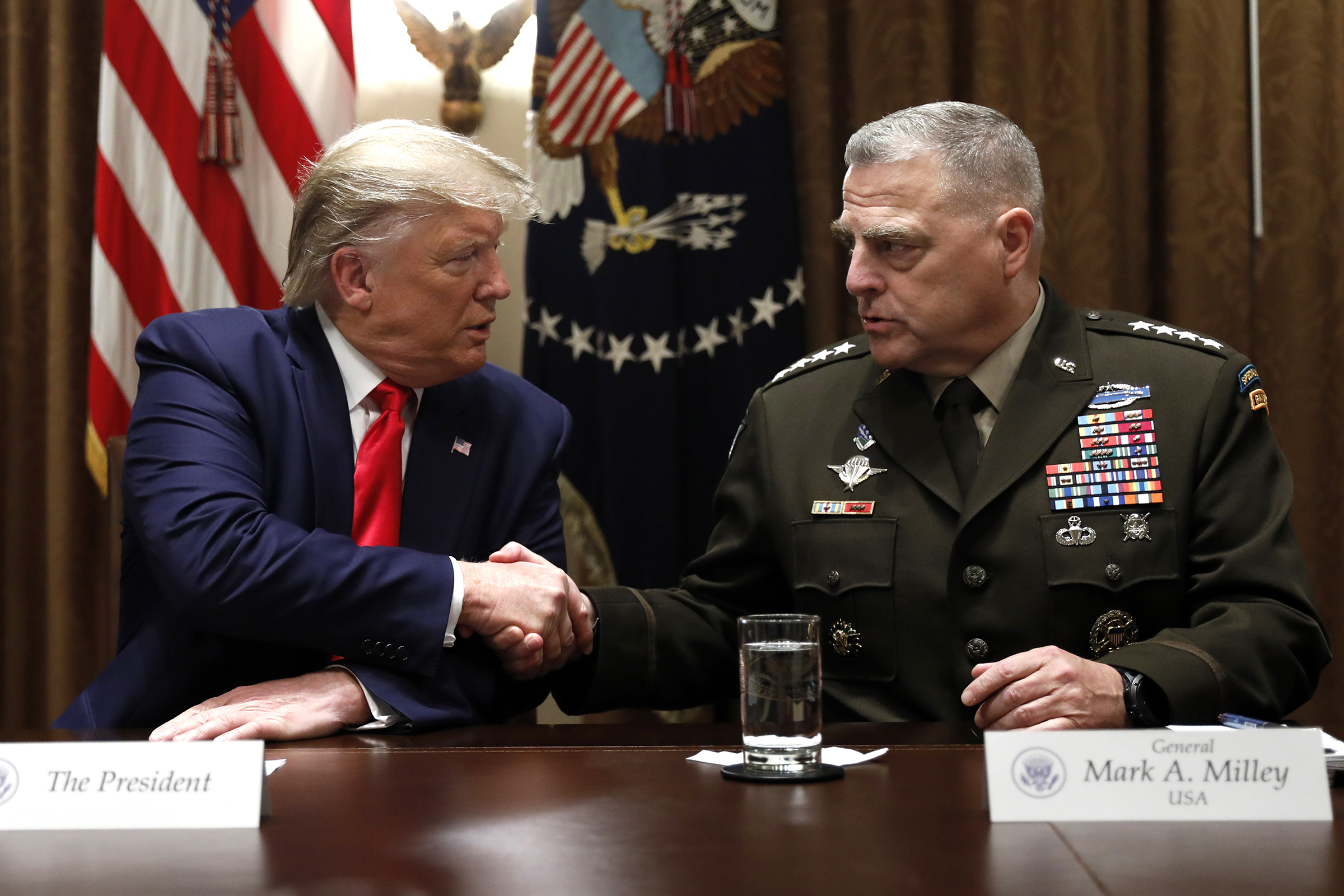 President Donald Trump shakes hands with Chairman of the Joint Chiefs of Staff Gen. Mark Milley during a briefing with senior military leaders in the Cabinet Room at the White House in Washington, on Oct. 7, 2019. (Carolyn Kaster—AP)