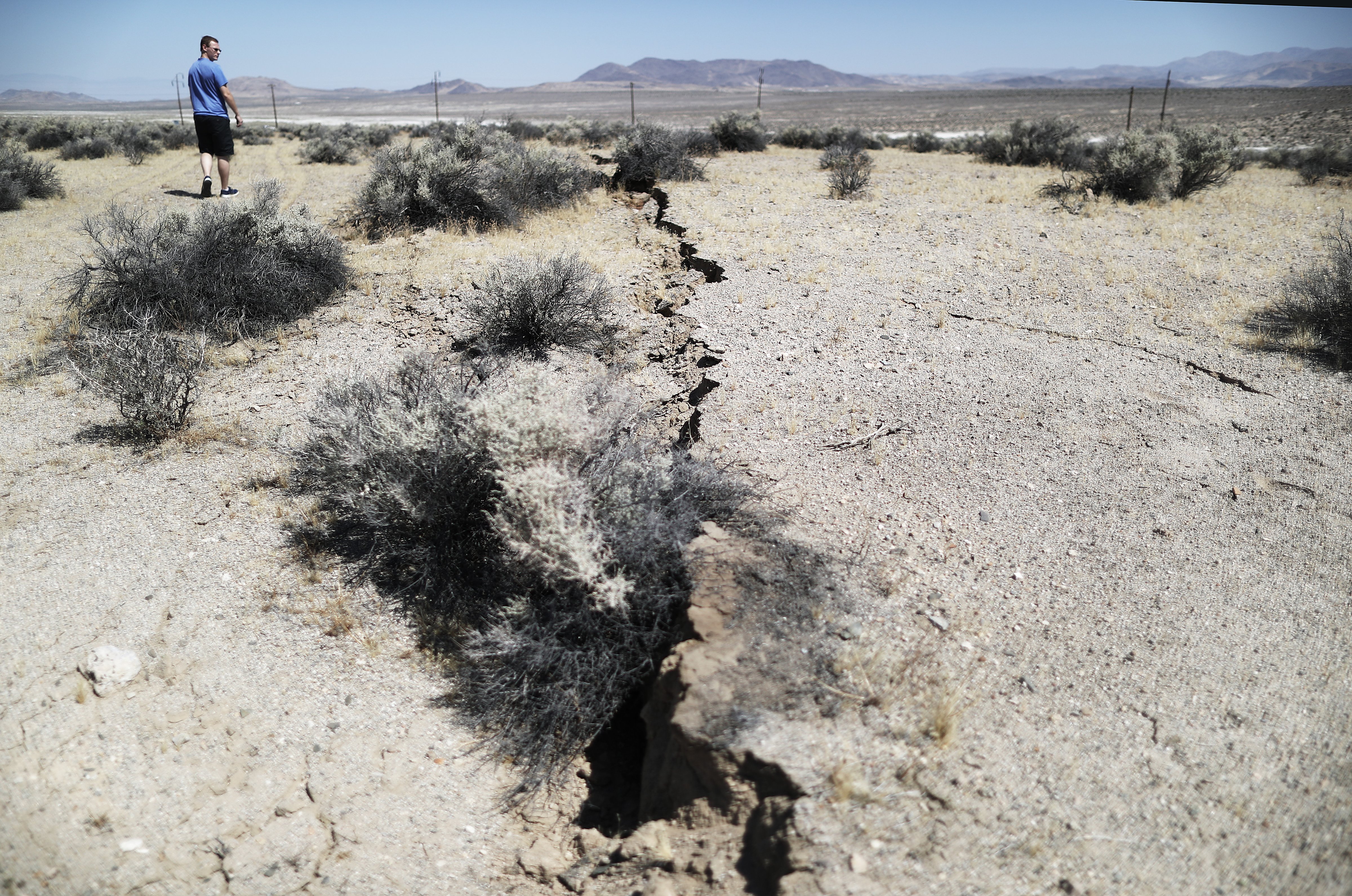 An onlooker views newly ruptured ground after a 7.1 magnitude earthquake struck in the area on July 6, 2019 near Ridgecrest, California. (Mario Tama—Getty Images)