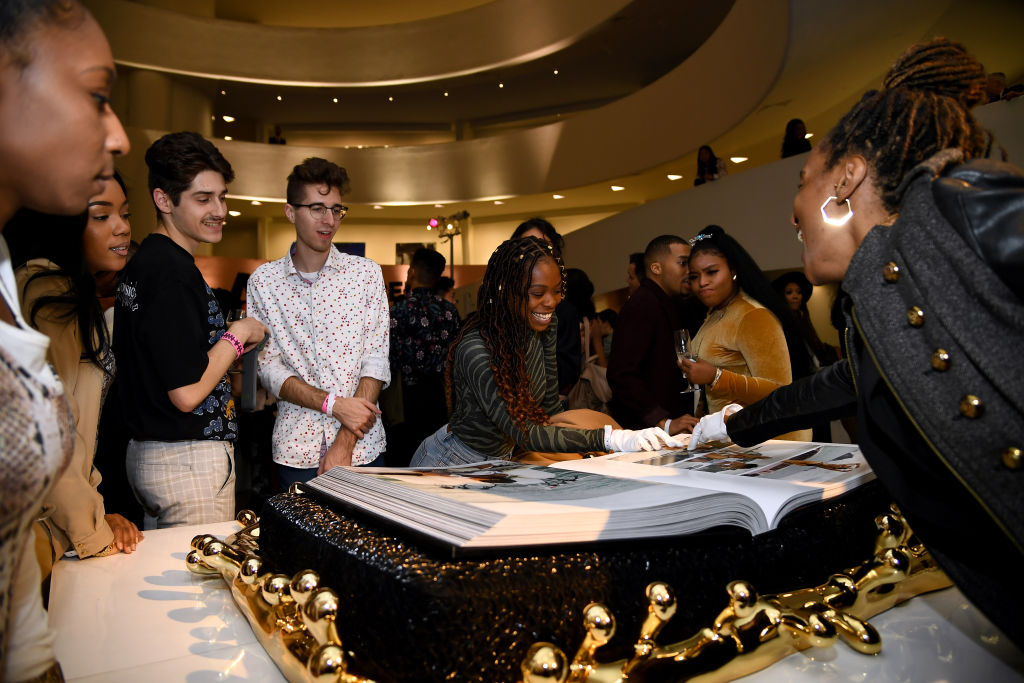 NEW YORK, NEW YORK - OCTOBER 11: Attendees look through the book during the launch of Rihanna's first Visual Autobiography, Rihanna, at Guggenheim Museum on October 11, 2019 in New York City. (Photo by Dimitrios Kambouris/Getty Images for Rihanna) (Dimitrios Kambouris&mdash;Getty Images for Rihanna)