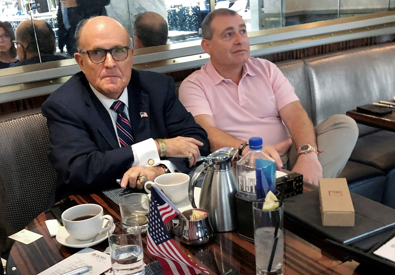 Giuliani and his client Lev Parnas on Sept. 20 at the Trump hotel in D.C. (Aram Roston—Reuters)