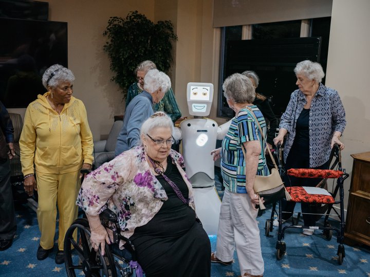 Residents at Knollwood Military Retirement Community in Washington, D.C. gather around Stevie II