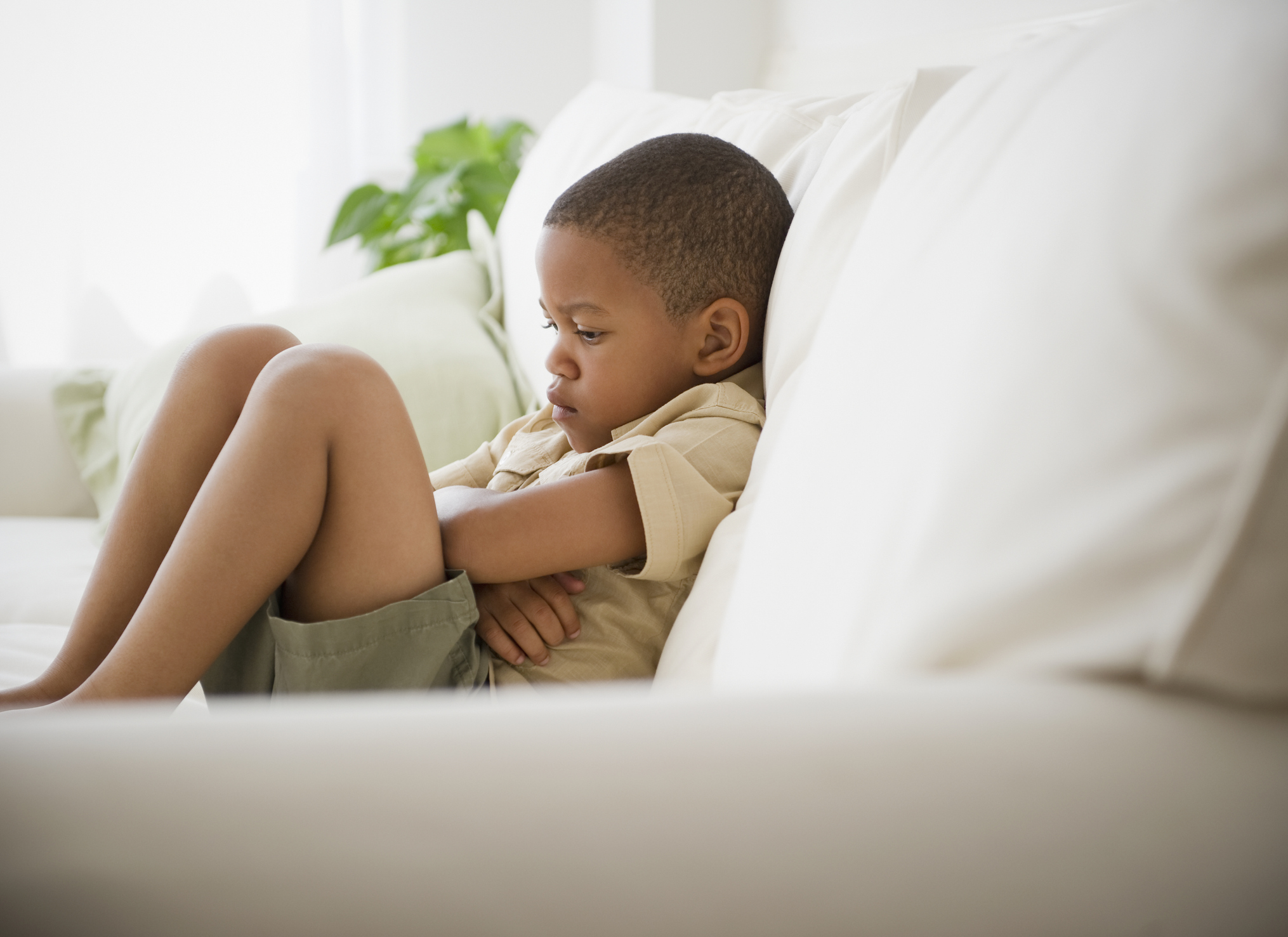 African American boy unhappy on sofa