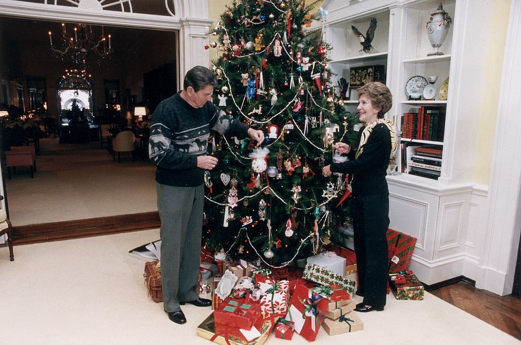 US President Ronald Reagan and First Lady Nancy Reagan decorate the White House Christmas tree, 24 December 1983. (Photo by Ronald Reagan Library/Getty Images) (Ronald Reagan Library—Getty Images)