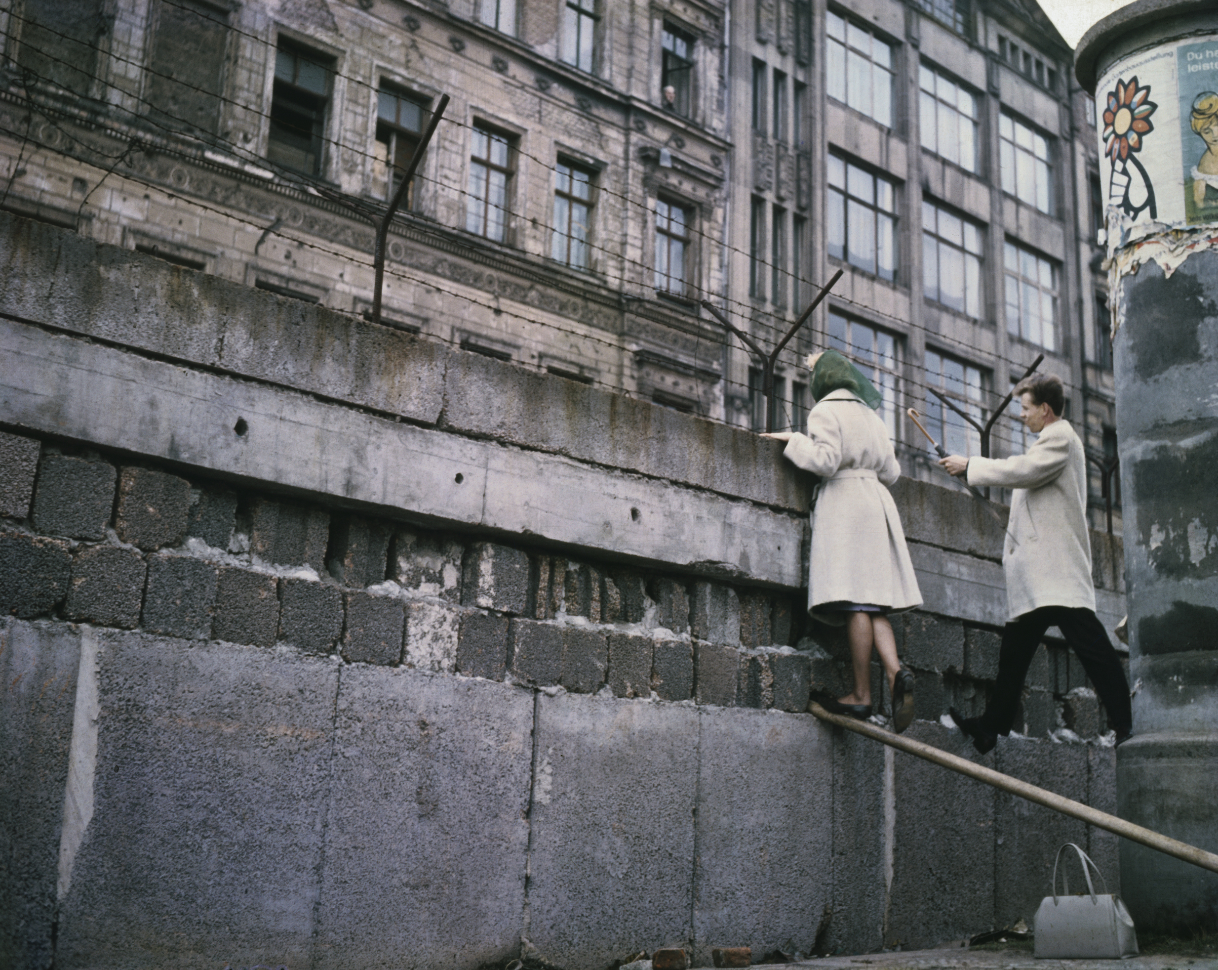 An undated photo of a West Berlin couple talking to relatives in an East Berlin apartment house (see upper window open) over the Berlin Wall. (Bettmann/Getty Images)