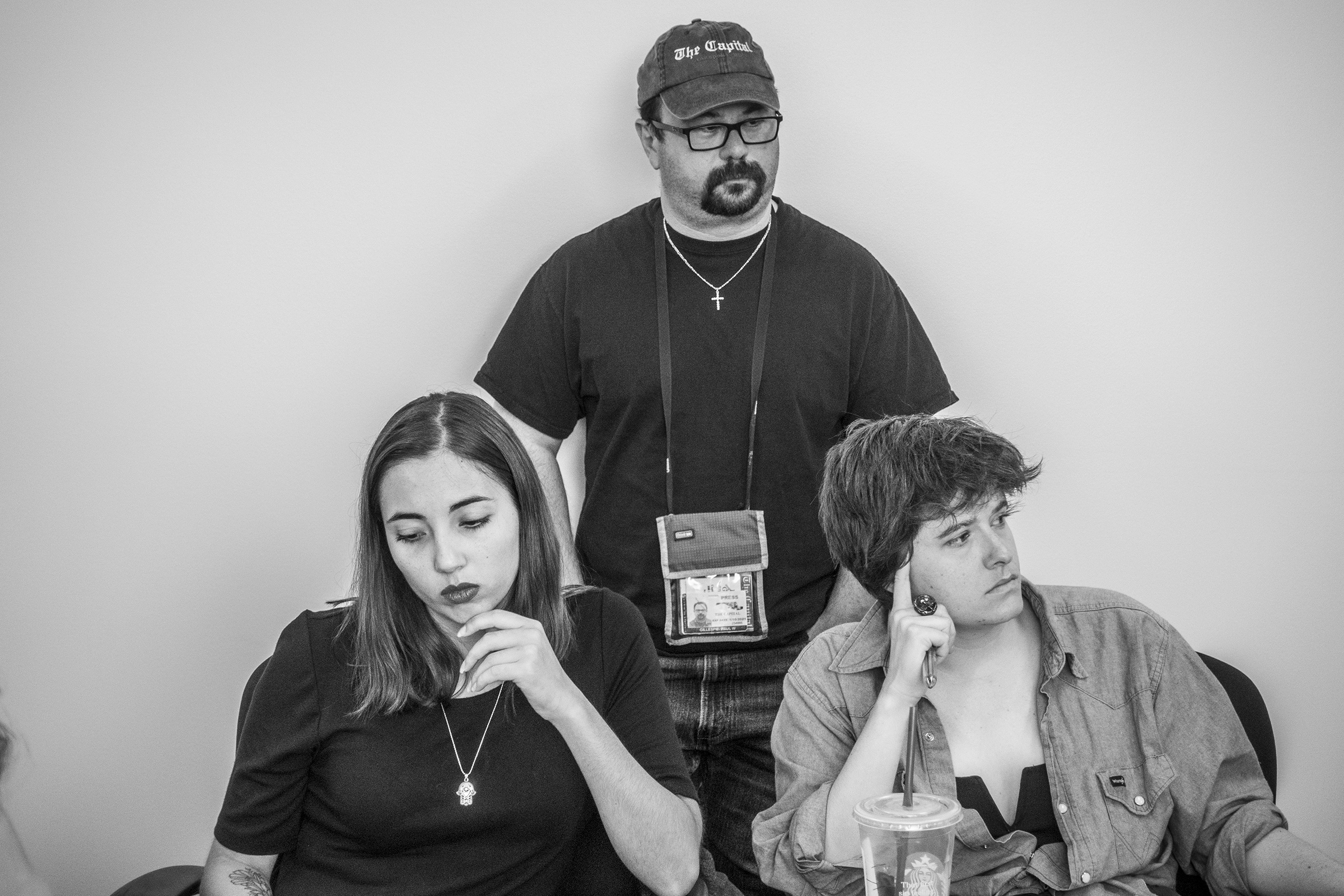 From left: Capital Gazette reporter Selene San Felice, photographer Paul Gillespie, and reporter Rachael Pacella, listen during a meeting at the newspaper, June 5, 2019. (Moises Saman—Magnum Photos for TIME)