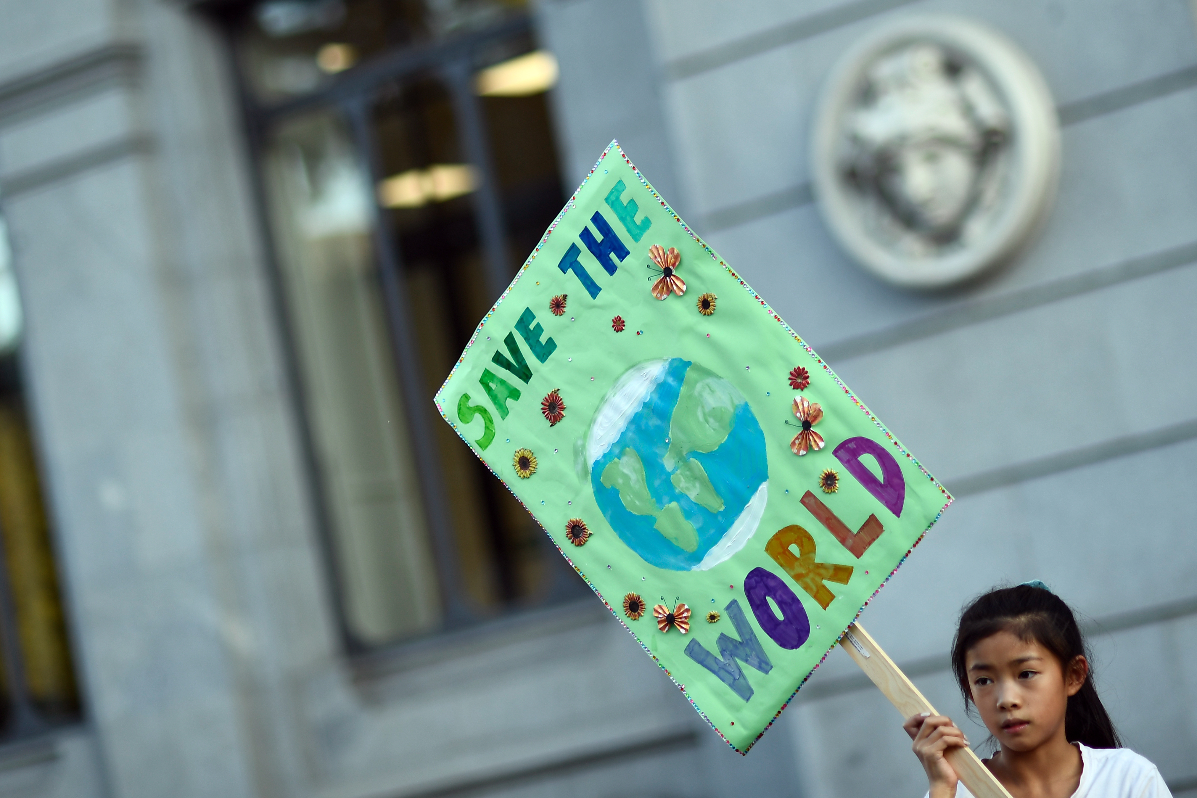 A girls holds a placard during global youth climate action strike in Madrid, on September 27, 2019 (OSCAR DEL POZO; AFP via Getty Images)