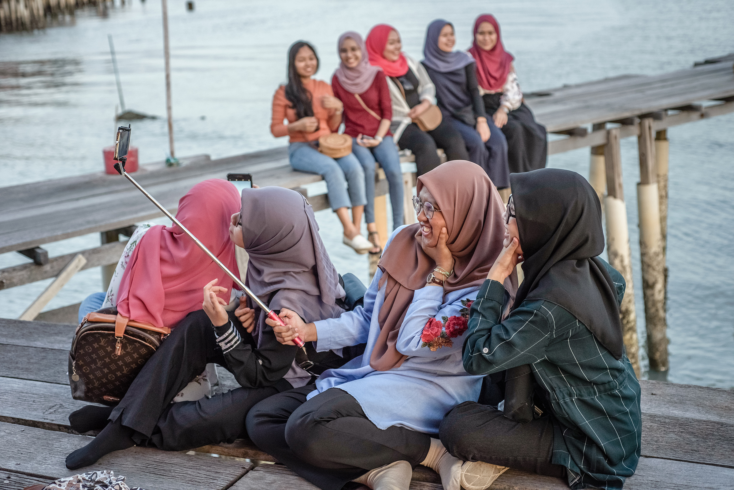 Muslim women enjoy the sunset in one of the Clan Jetties villages, in George Town, Penang Island, Malaysia, in January 2019. (Oleksandr Rupeta—NurPhoto via Getty Images)