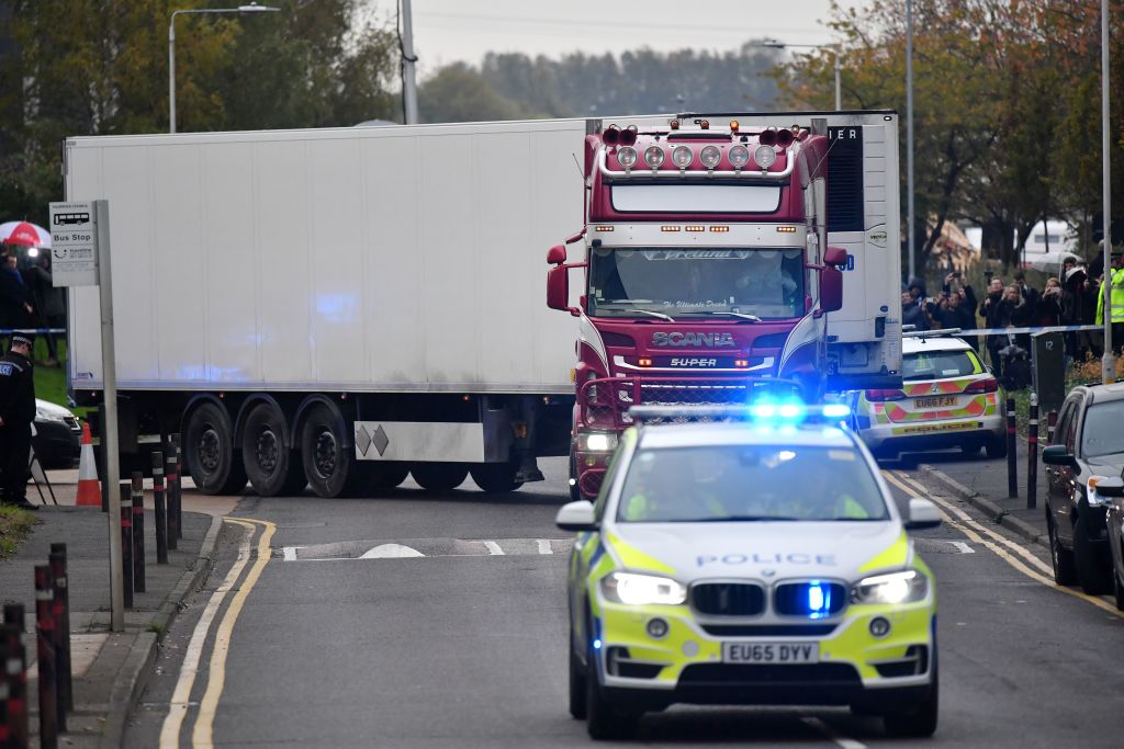 Police officers drive away a truck in which 39 dead bodies were discovered on Oct. 23, in the U.K. The victims are believed to be Vietnamese nationals. (Ben Stansall—AFP/Getty Images)