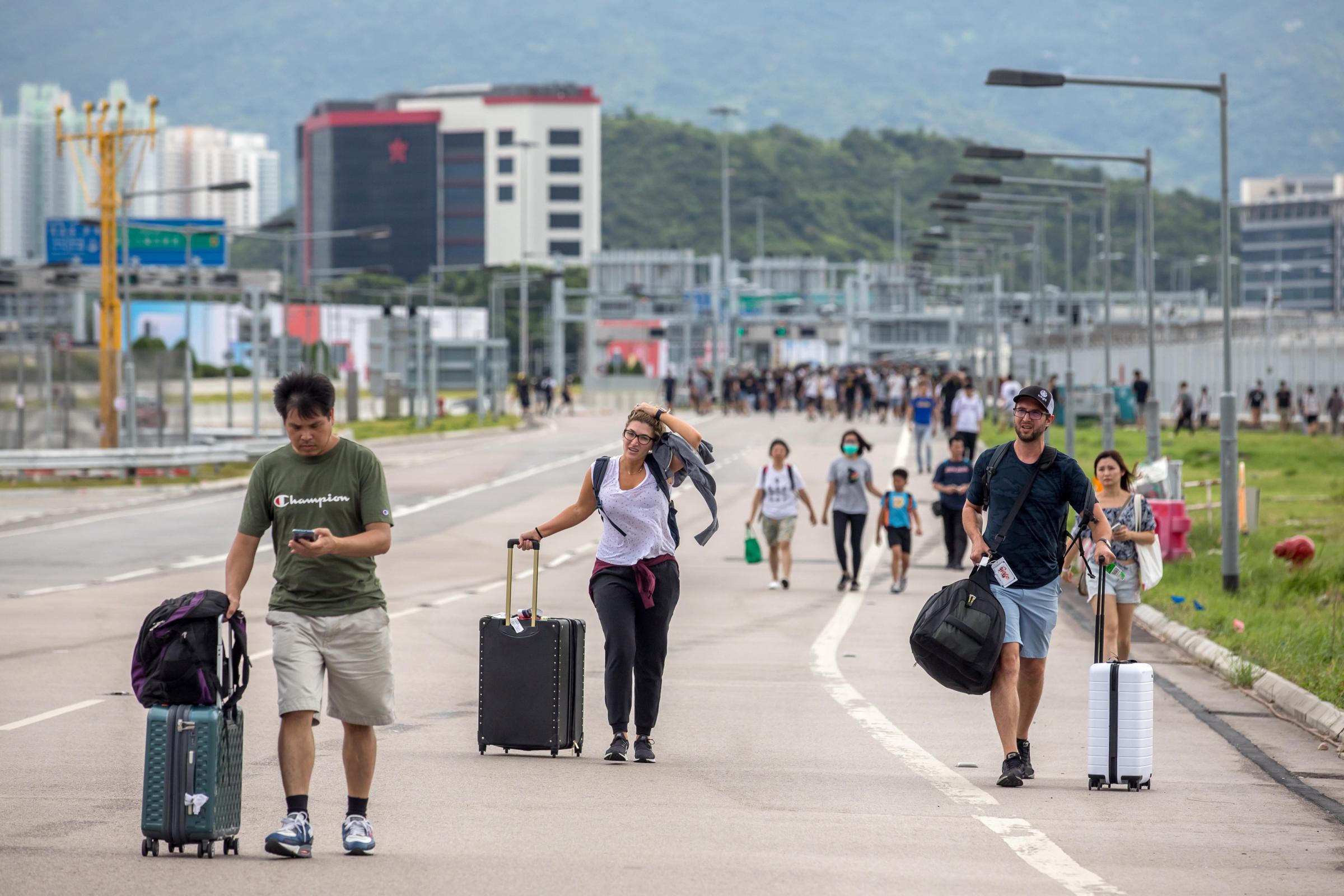Hong Kong Demonstrators Swarm to Airport, Disrupting Transport