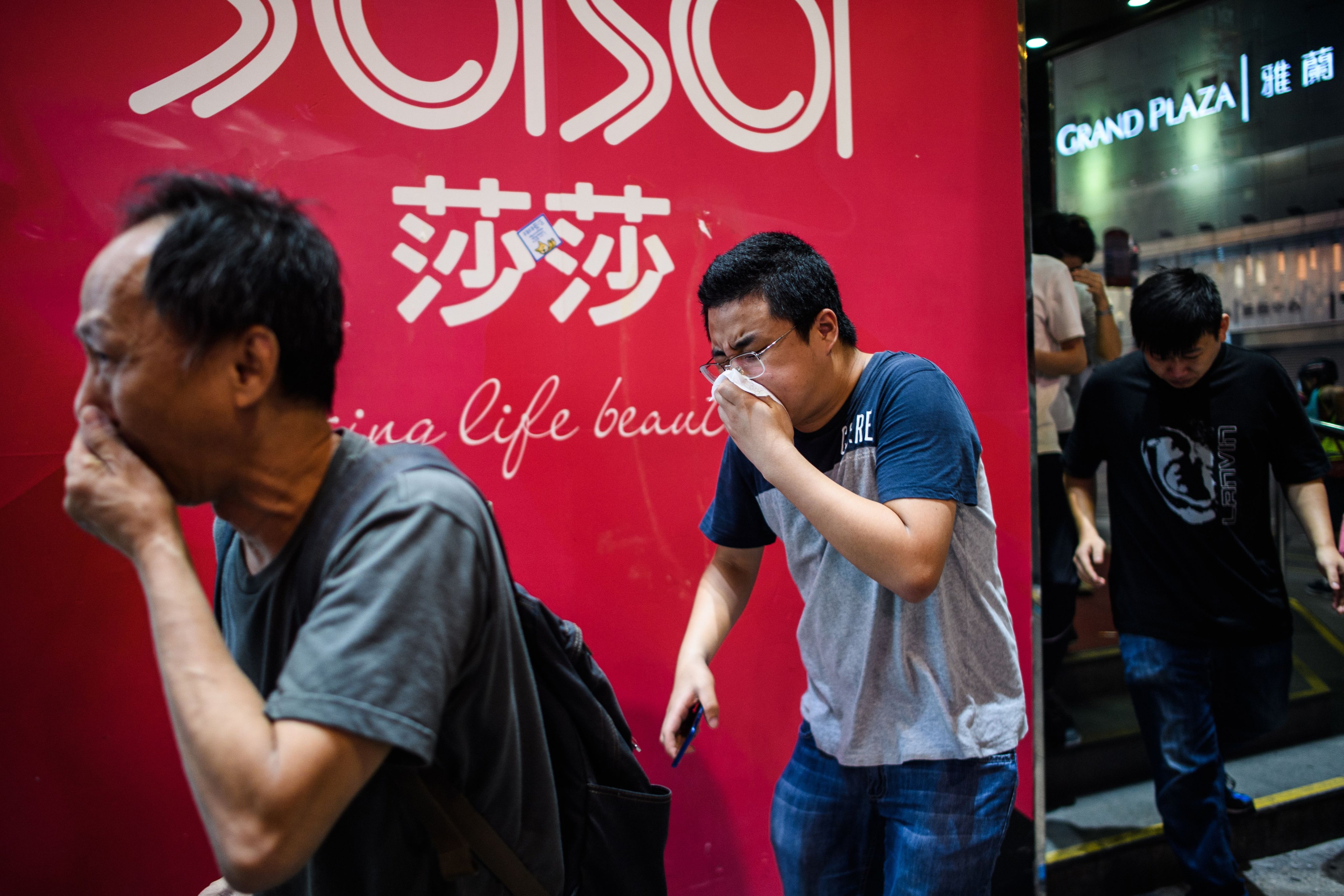 Bystanders react after police fired tear gas to disperse residents and protesters in the Mong Kok district of Kowloon in Hong Kong on October 27, 2019. (ANTHONY WALLACE—AFP via Getty Images)