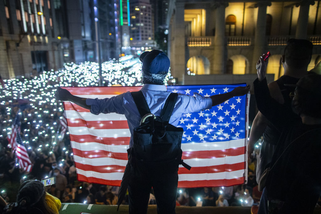 A demonstrator holds a U.S. flag during a rally in Hong Kong on Oct. 14, 2019. (Chan Long Hei—Bloomberg/Getty Images)
