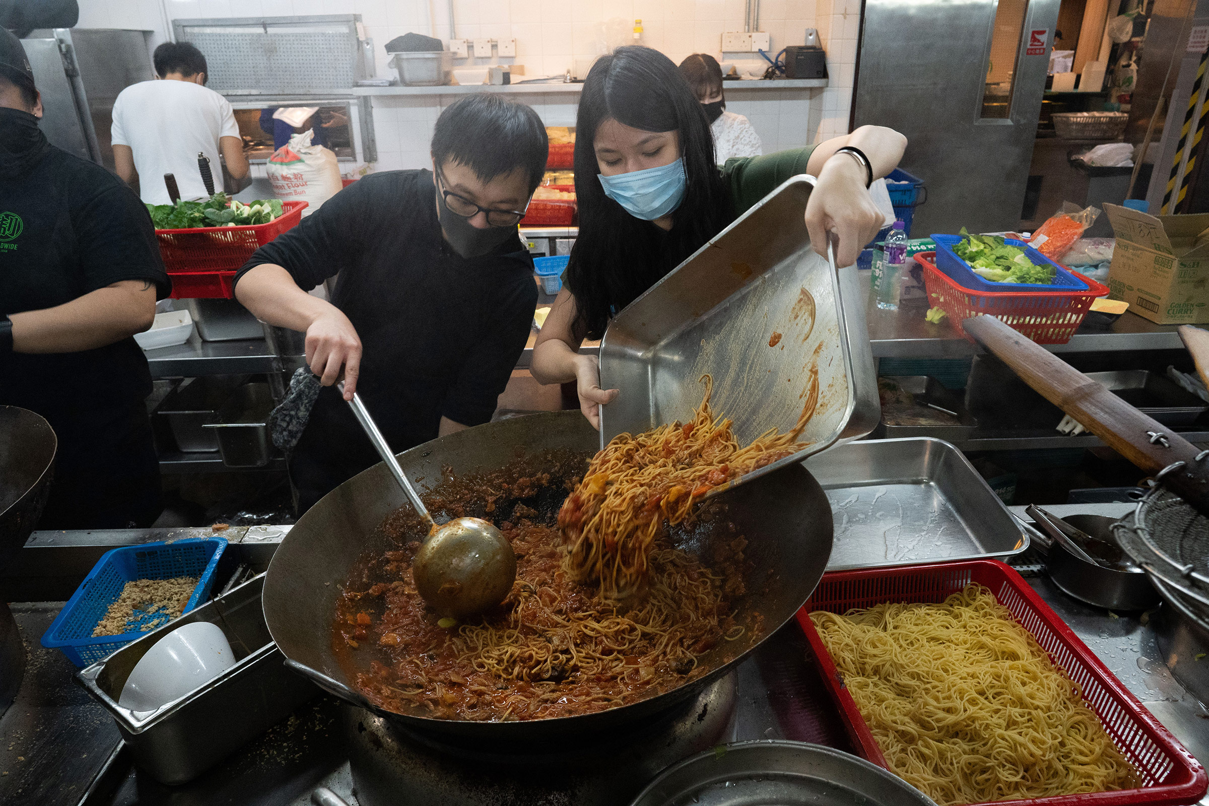 Volunteers, some of whom had never cooked before, help prepare food for the protestors gathered at PolyU, Nov. 14.