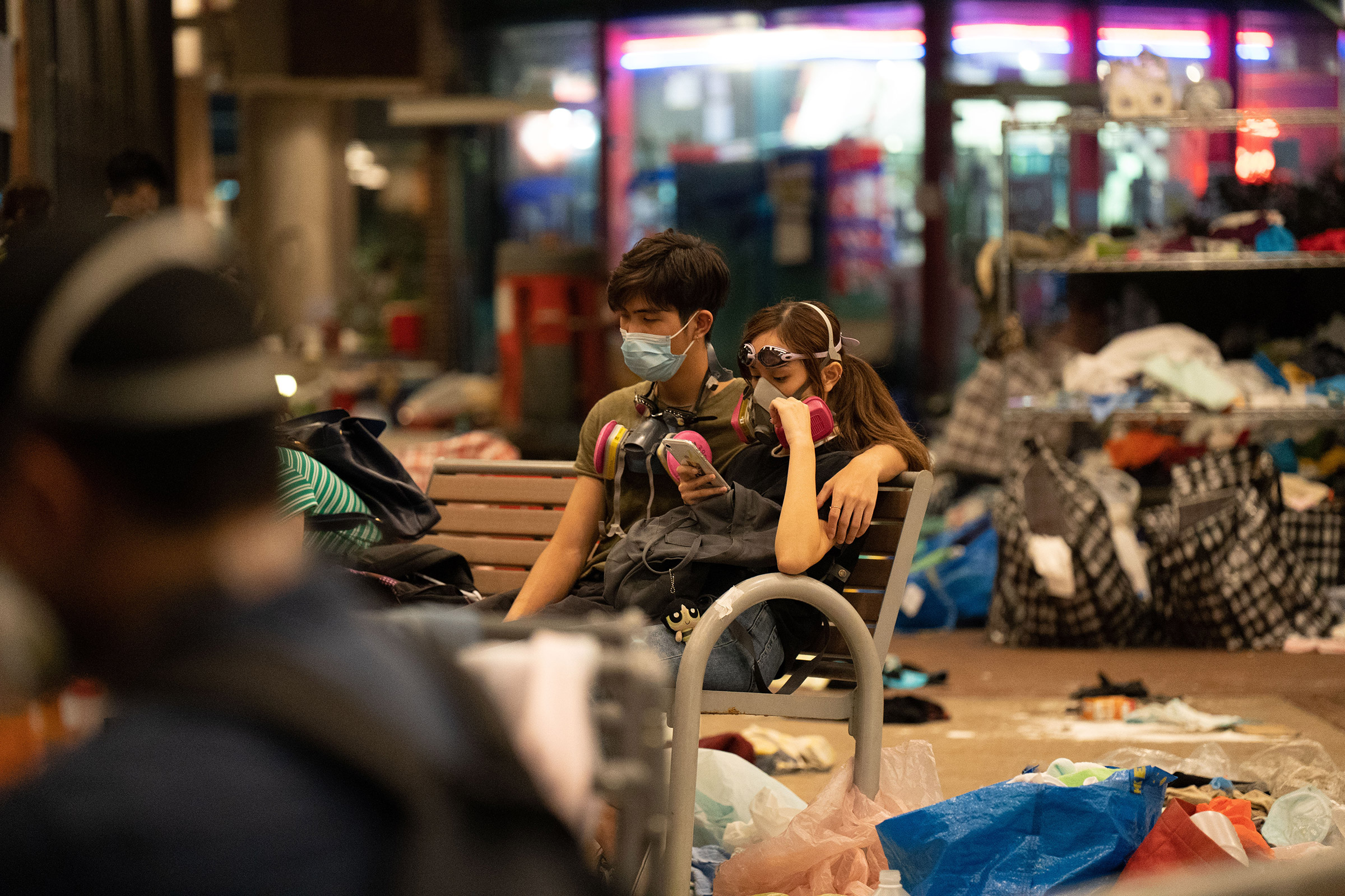 A couple waits for news of a rescue operation for protestors still trapped in PolyU, Nov. 18. (Bing Guan)