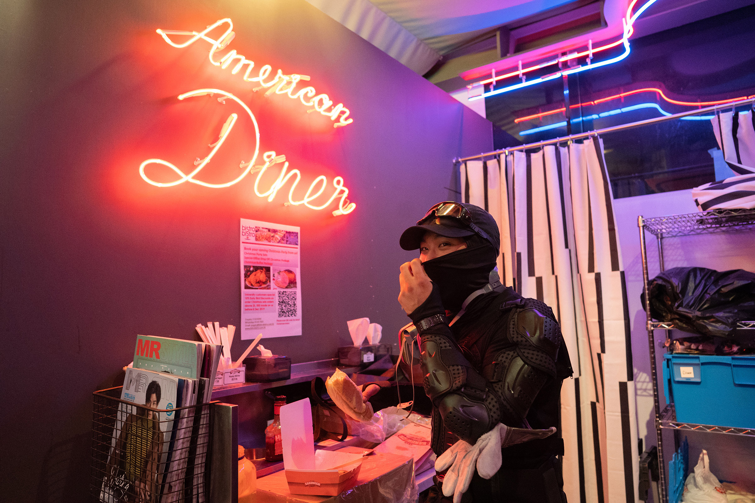 A frontline protestor eats a late-night hot dog at the "American Diner" on the Polytechnic University campus, Nov. 15, 2019.