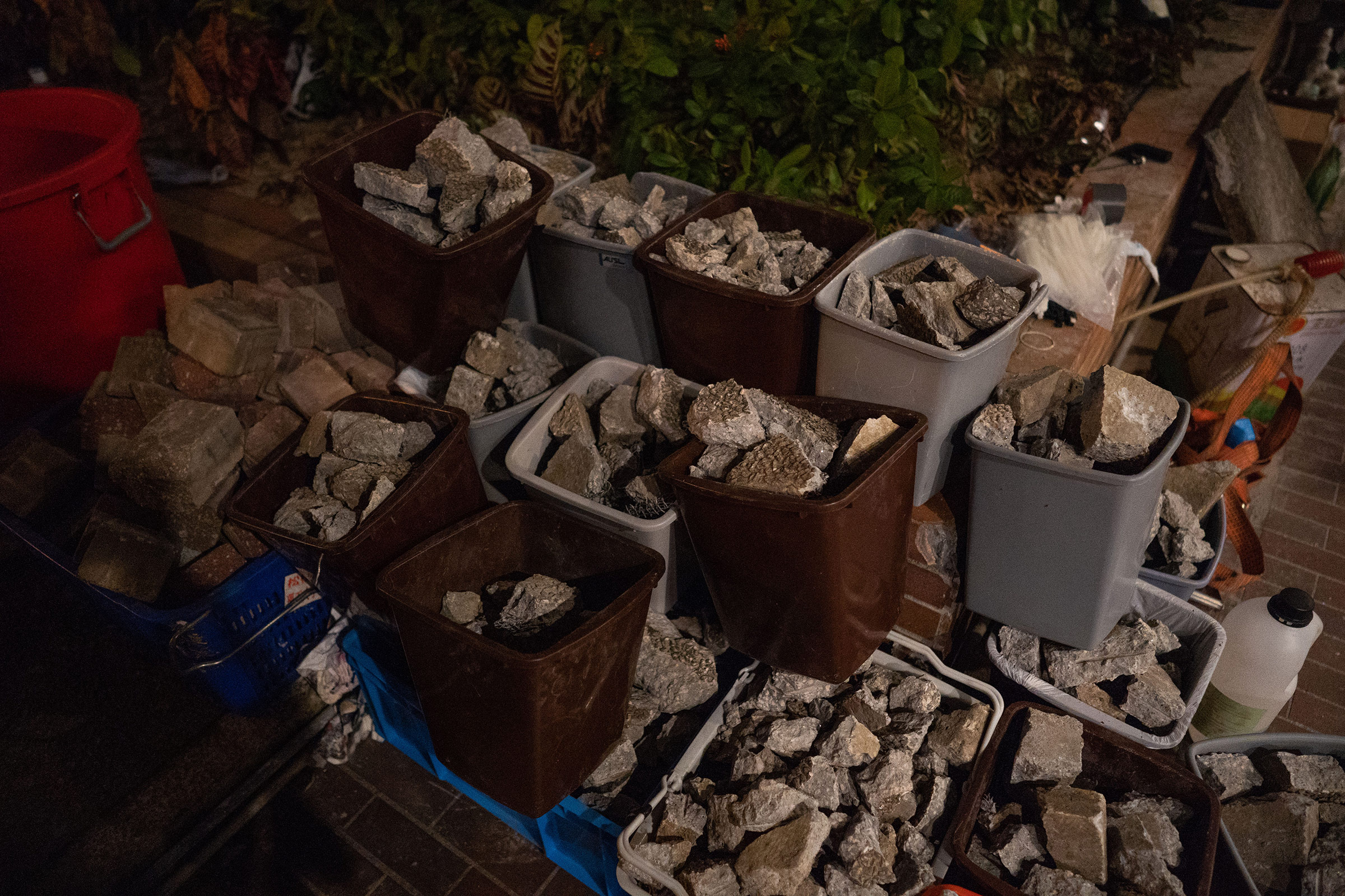 Bricks, used both to slow down advancing police as well as projectiles, are neatly sorted into garbage bins at PolyU. (Bing Guan)
