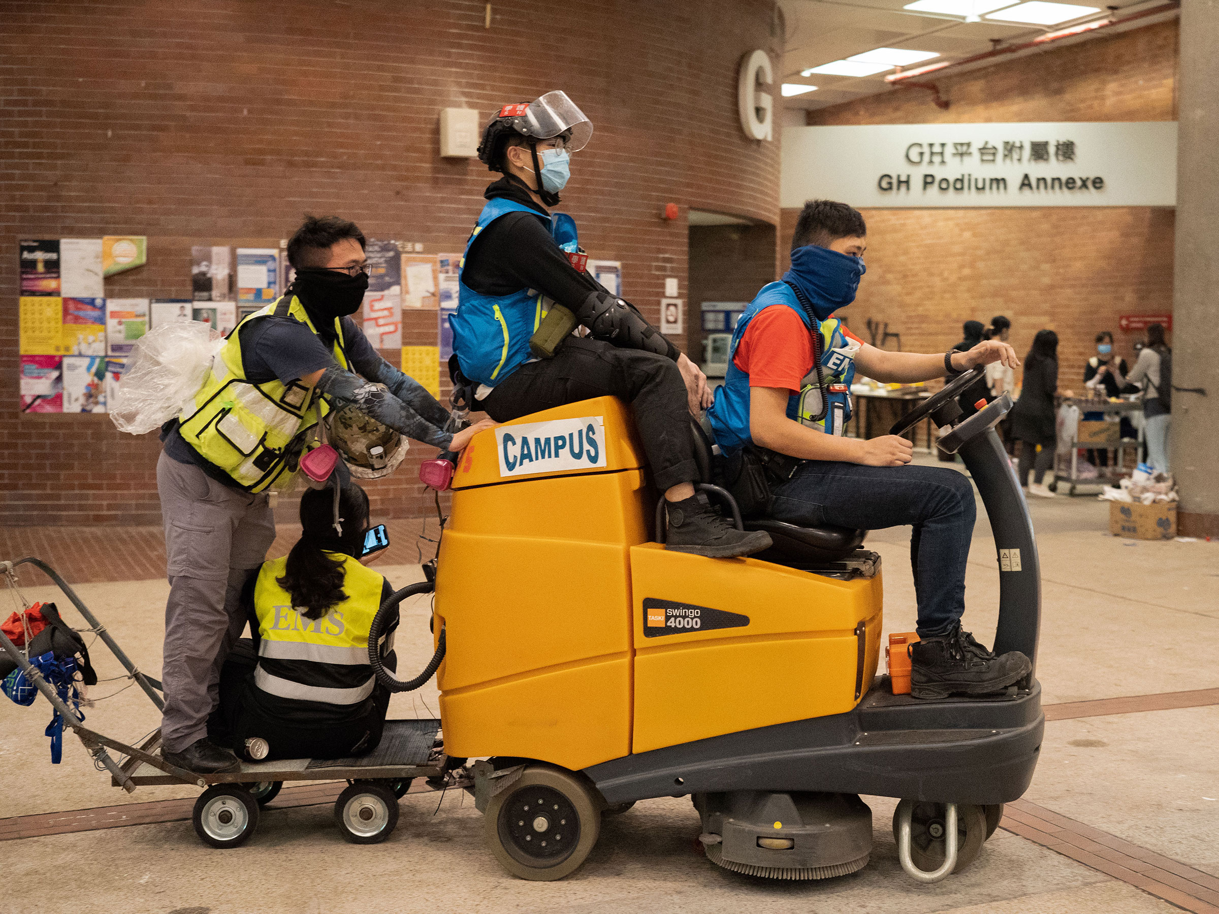 First-aiders convert a floor cleaning machine into a makeshift ambulance, Nov. 14. (Bing Guan)