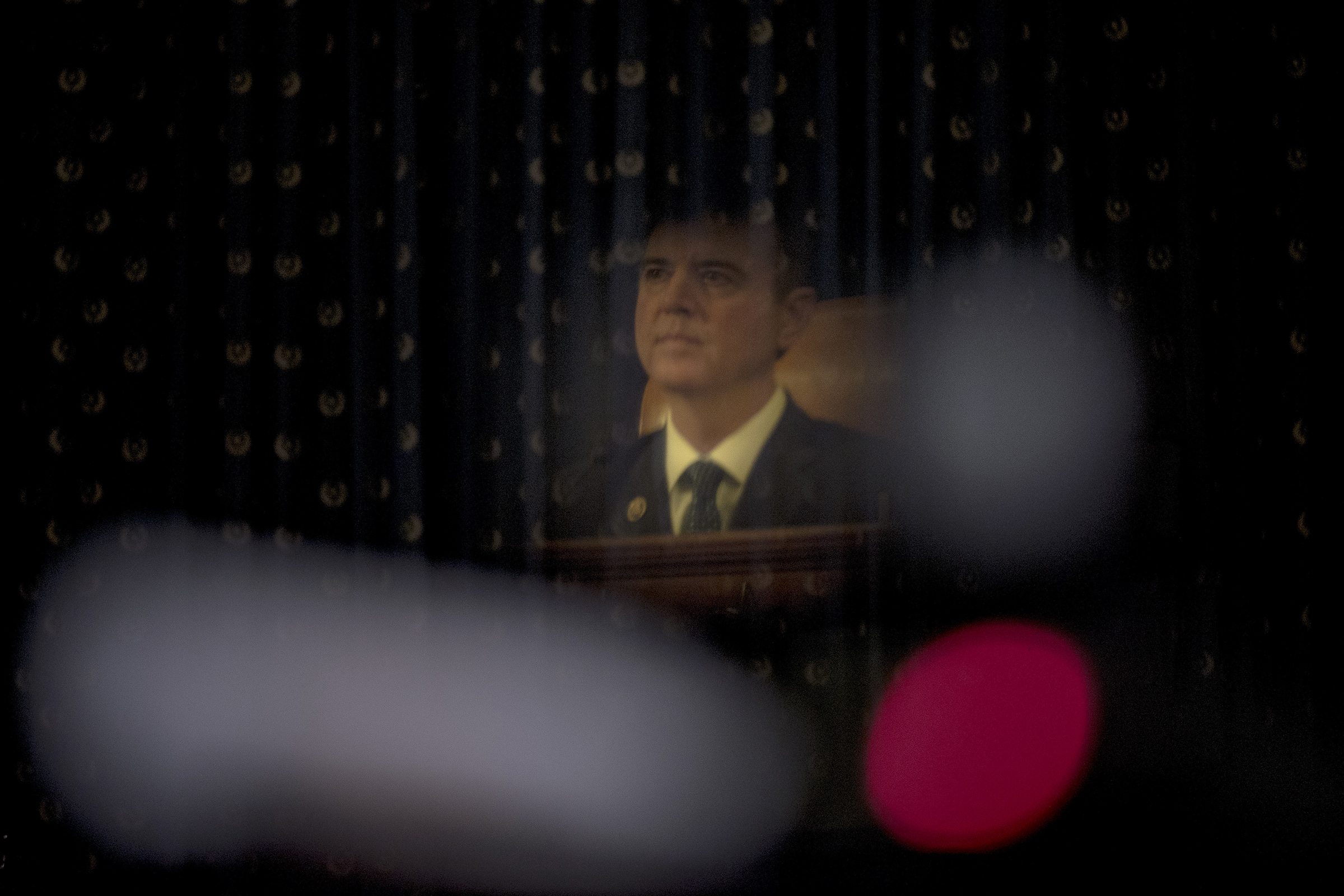 A reflection of Chairman Adam Schiff (D-Calif.) listening to testimony during the House Intelligence Committee hearing on the impeachment inquiry on Capitol Hill in Washington D.C., on Nov. 19, 2019. (Gabriella Demczuk for TIME)