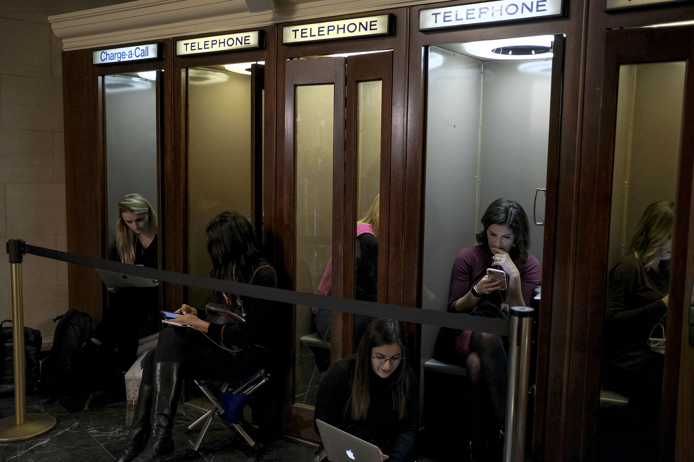 11/19/19, Capitol Hill, Washington, D.C. Members of the press sit in phone booths outside the House Intelligence Committee room during the hearing on the impeachment inquiry at the Longworth House Office building on Capitol Hill in Washington, D.C. on Nov. 19, 2019.Gabriella Demczuk / TIME