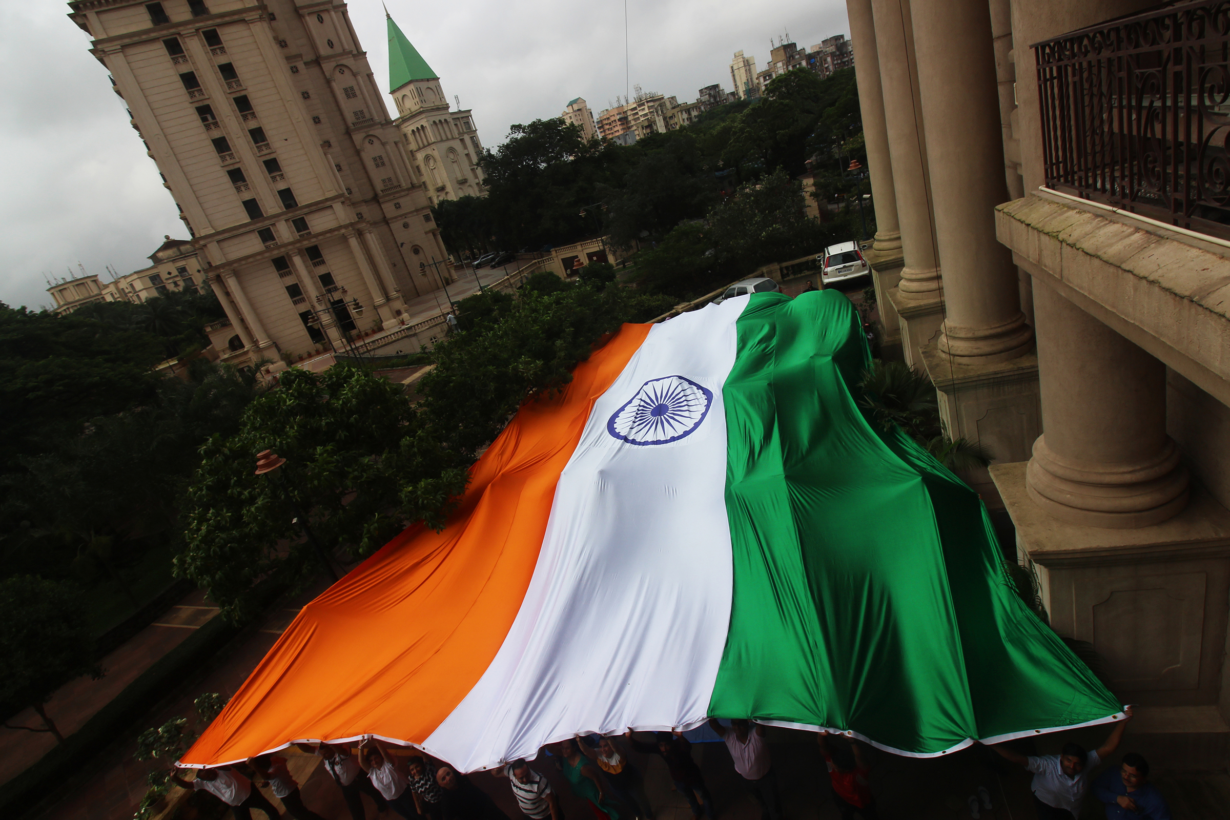 People hold a giant Indian national flag ahead of the 73rd Independence Day celebrations in Mumbai in August 2019. (Himanshu Bhatt—NurPhoto/Getty Images)