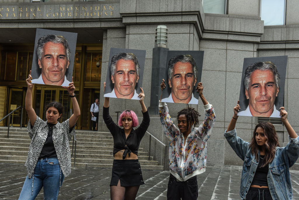 A protest group called "Hot Mess" hold up signs of Jeffrey Epstein in front of the Federal courthouse on July 8, 2019 in New York City. (Stephanie Keith—Getty Images)