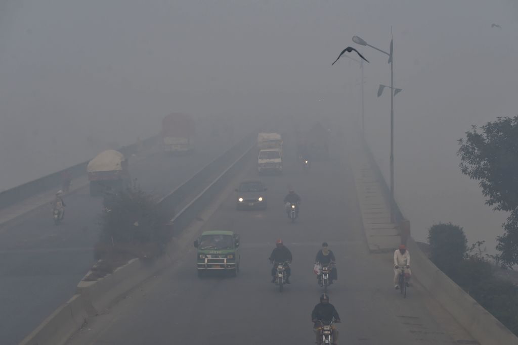 Commuters drive amid heavy smog conditions in Lahore, Pakistan on Nov. 21, 2019. (ARIF ALI&mdash;AFP/Getty Images)