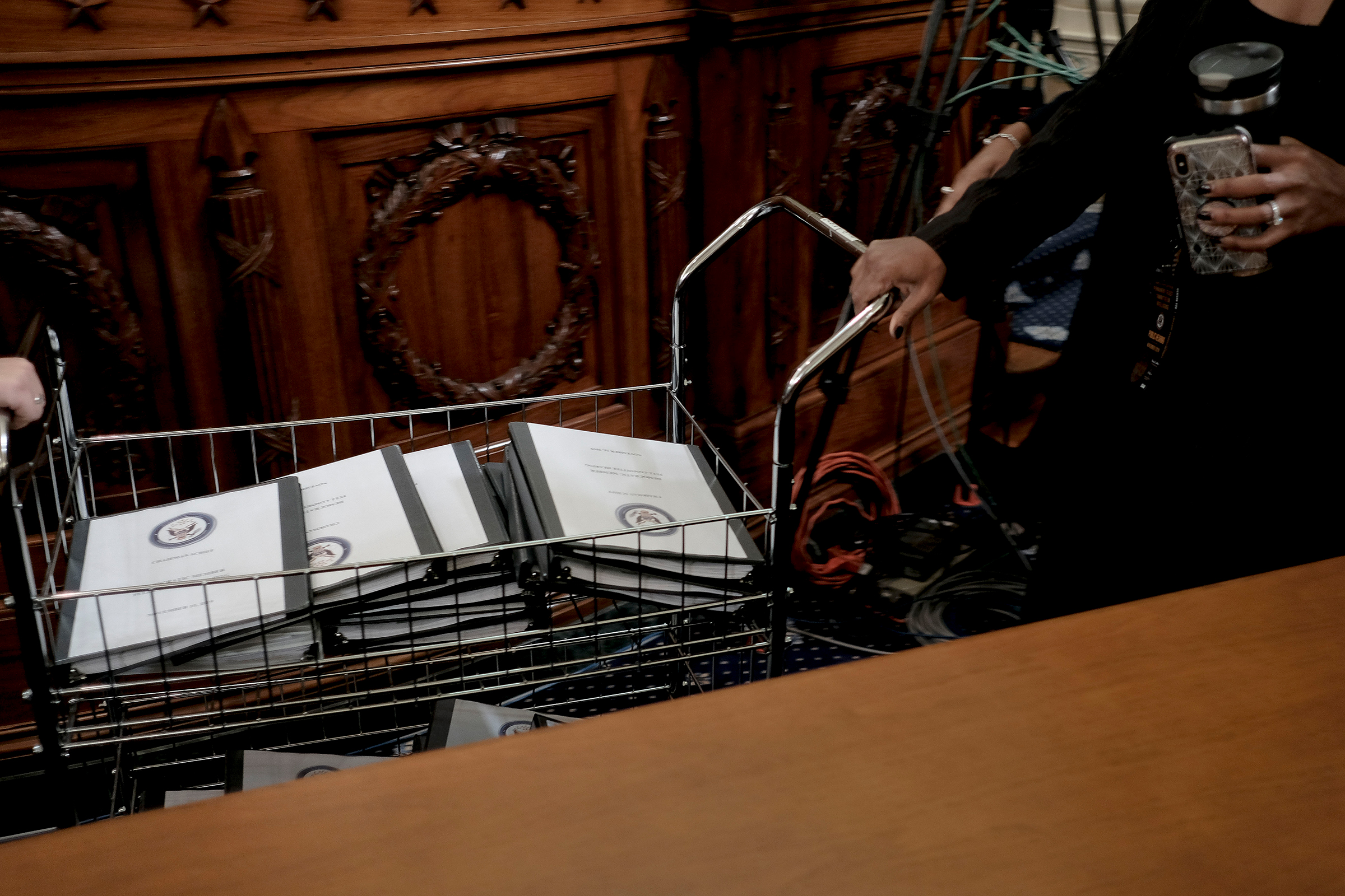 Binders full of notes, testimonies, talking points and more are distributed for Democratic members of Congress at the House Intelligence Committee hearing on the impeachment inquiry, in Washington, D.C., on Nov. 15, 2019. (Gabriella Demczuk for TIME)