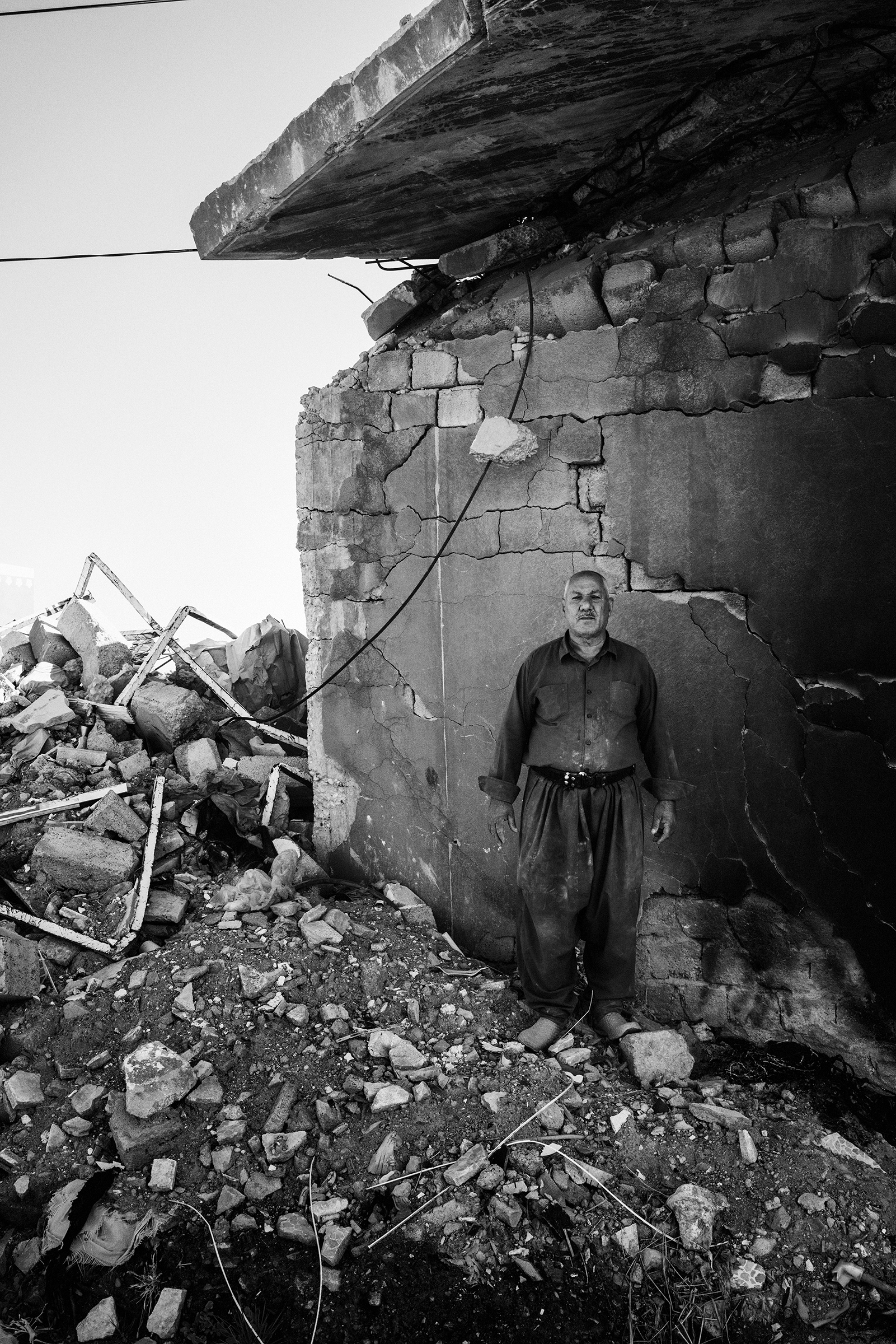 Mohsin Hairan Aswad, 60, a wealthy Yazidi Kurd from Bashiqa, stands in the remains of one of the seven homes that he owns. His homes were destroyed during the fighting to liberate the town from ISIS control in 2016. The next year, his son Faris, a local policeman in Mosul, was killed by an ISIS sniper. (Moises Saman—Magnum Photos for TIME)