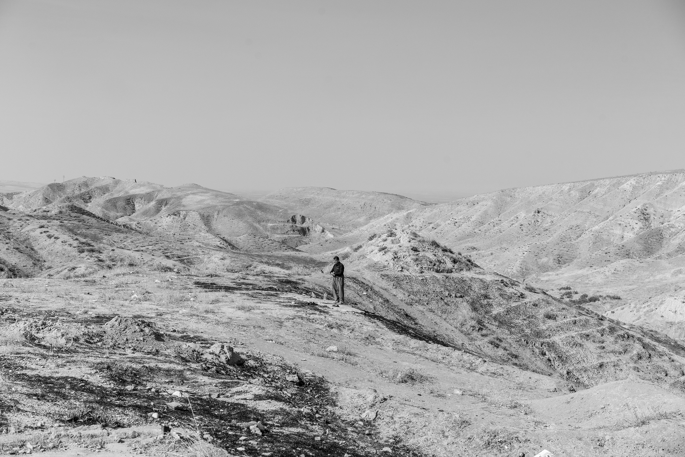 A Kurdish man prays on a hill near the Bardarash camp on Oct. 31. (Moises Saman—Magnum Photos for TIME)