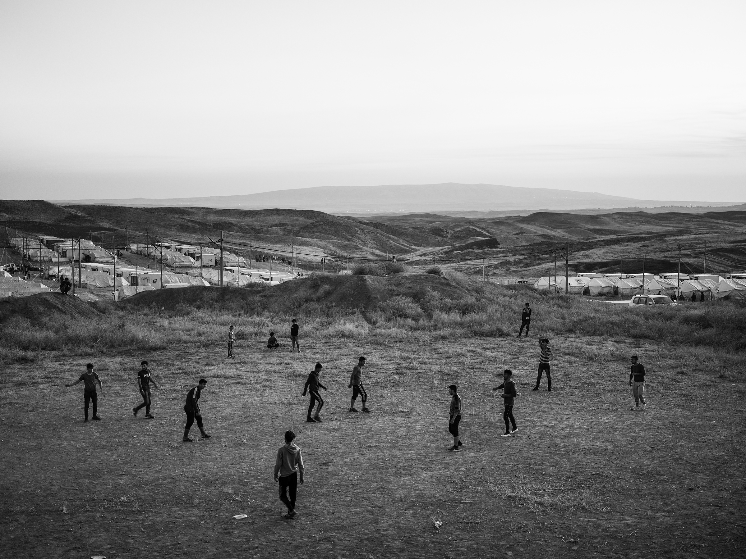 Refugees play soccer inside the Bardarash camp, which had hosted Iraqis displaced by the offensive against ISIS in Mosul and reopened in October to accommodate Kurds fleeing the Turkish offensive in Syria. (Moises Saman—Magnum Photos for TIME)