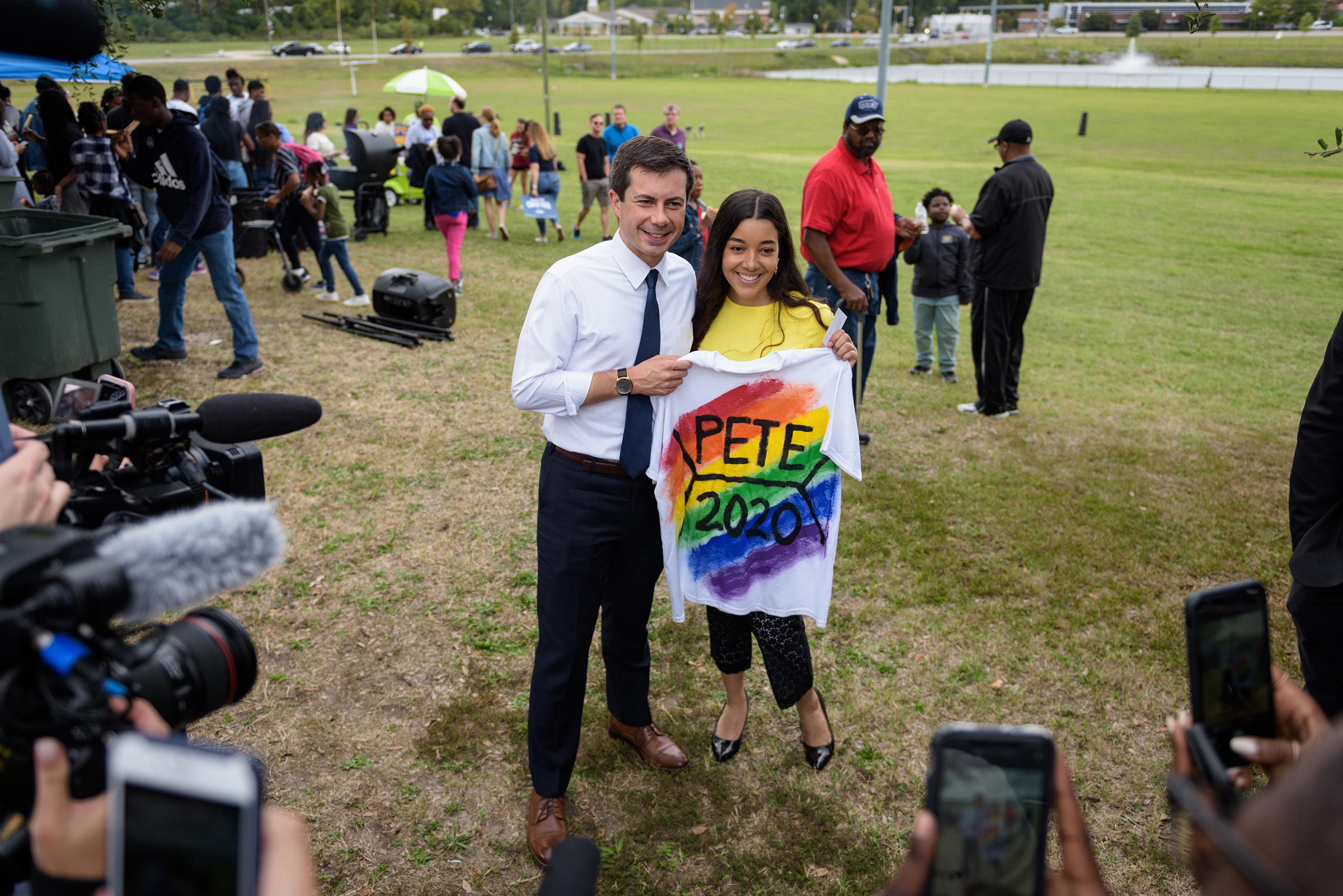 Mayor Pete Buttigieg of South Bend, Ind., a Democratic presidential hopeful, poses for a photo with Kashmir Imani, holding a T-shirt she designed, during a homecoming tailgate event at Allen University, a historically black campus in Columbia, S.C., on Oc