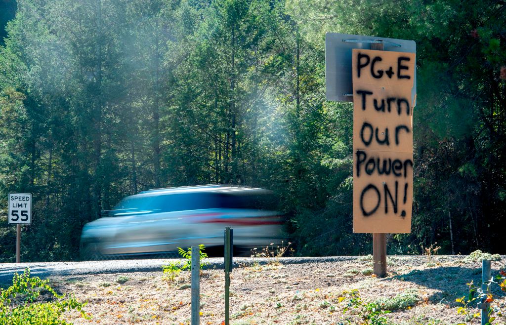 A sign calling for utility company PG&amp;E to turn the power back on is seen on the side of the road during a statewide blackout in Calistoga, California, on October, 10, 2019. (JOSH EDELSON&mdash;AFP via Getty Images)