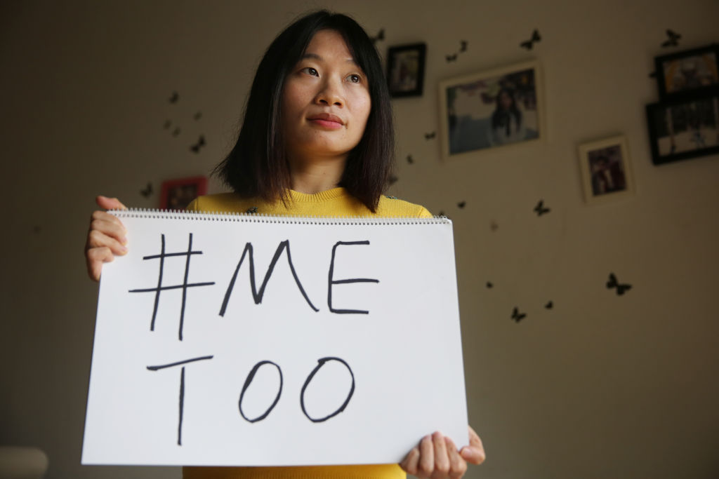 Sophia Huang Xueqin, a freelance journalist who was a key figure in the #MeToo movement in China, holds a sign at her home on Dec. 8, 2017. (Thomas Yau—South China Morning Post/Getty Images)