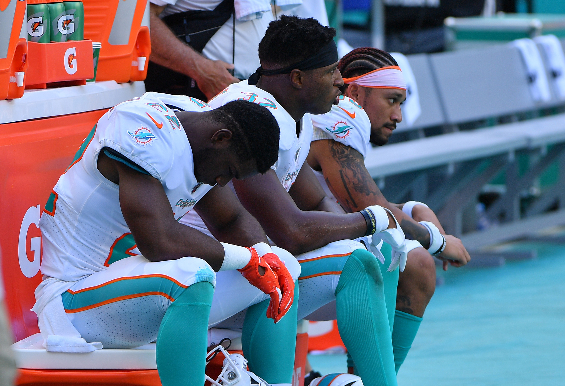 Miami players take in a 59-10 loss to Baltimore on Sept. 8