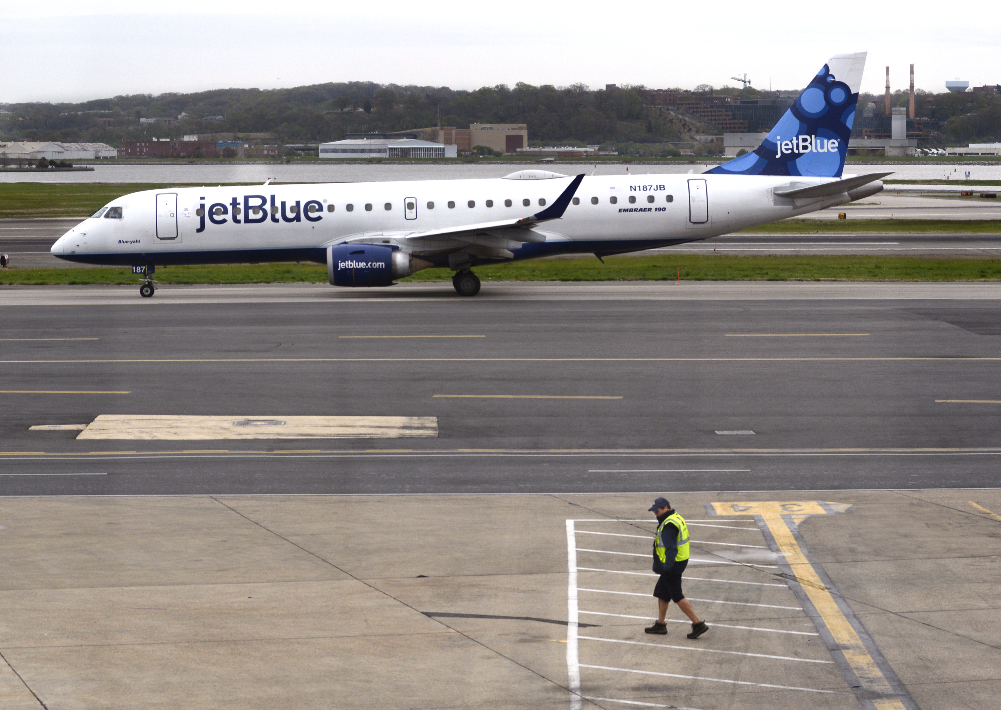 A JetBlue Airways Embraer 190 jet taxis to a gate after landing at Ronald Reagan Washington National Airport in Washington, D.C. (Robert Alexander&mdash;Getty Images)