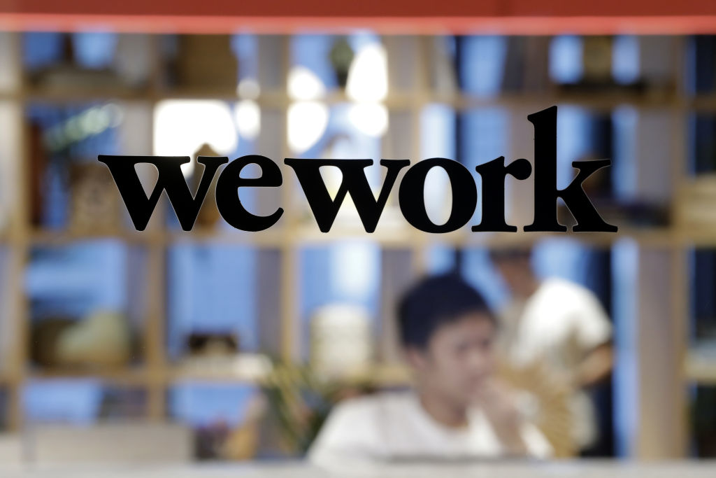 The WeWork logo sits on display on a glass door of the entrance to the WeWork Ocean Gate Minatomirai co-working office space, operated by The We Company, in Yokohama, Japan, on Friday, Oct. 11, 2019. (Kiyoshi Ota&mdash;Bloomberg via Getty Images)