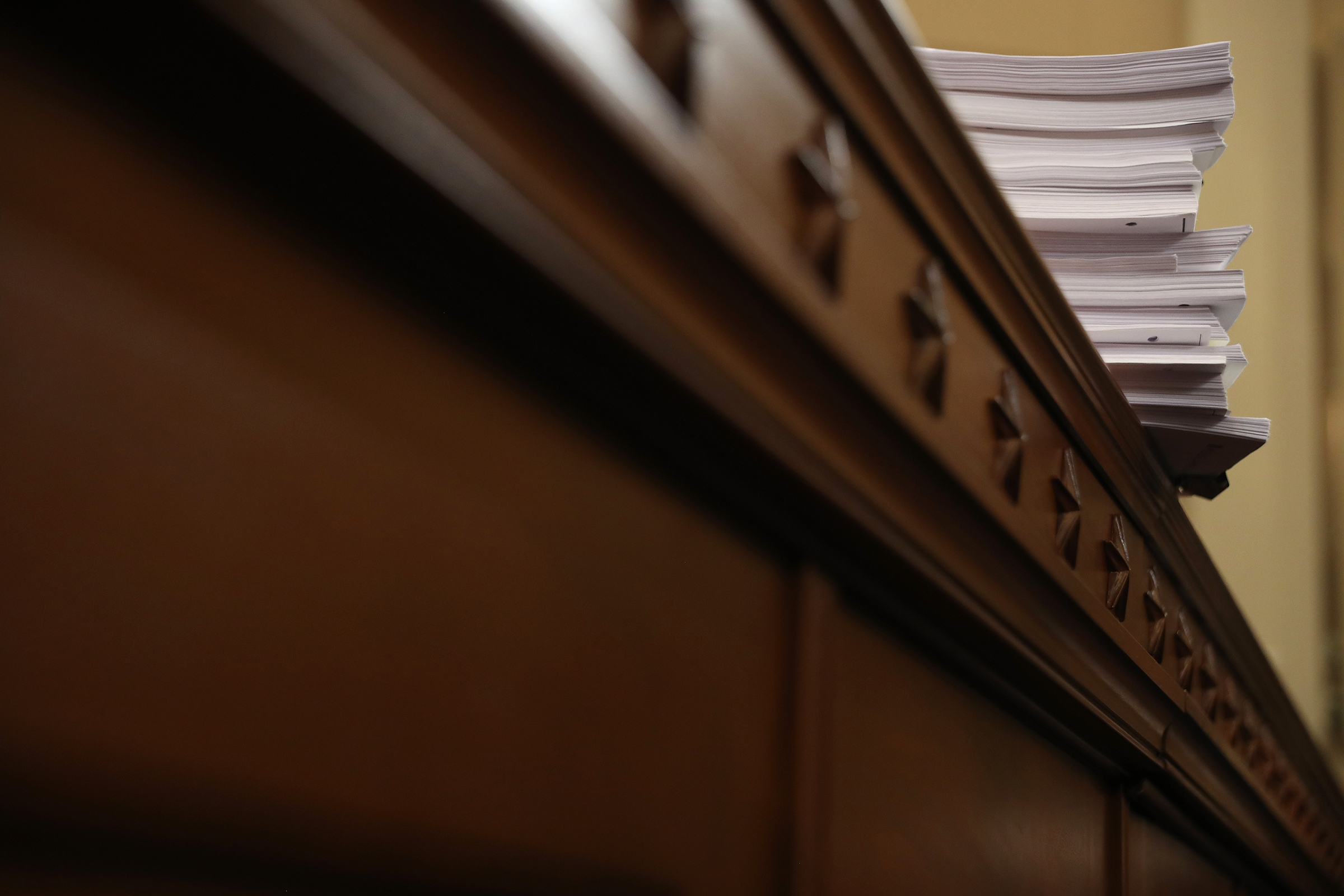 A stack of transcrips of depositions are shown during the third day of open hearings in the impeachment inquiry against President Donald Trump, Nov. 19, 2019. (Chip Somodevilla—Getty Images)