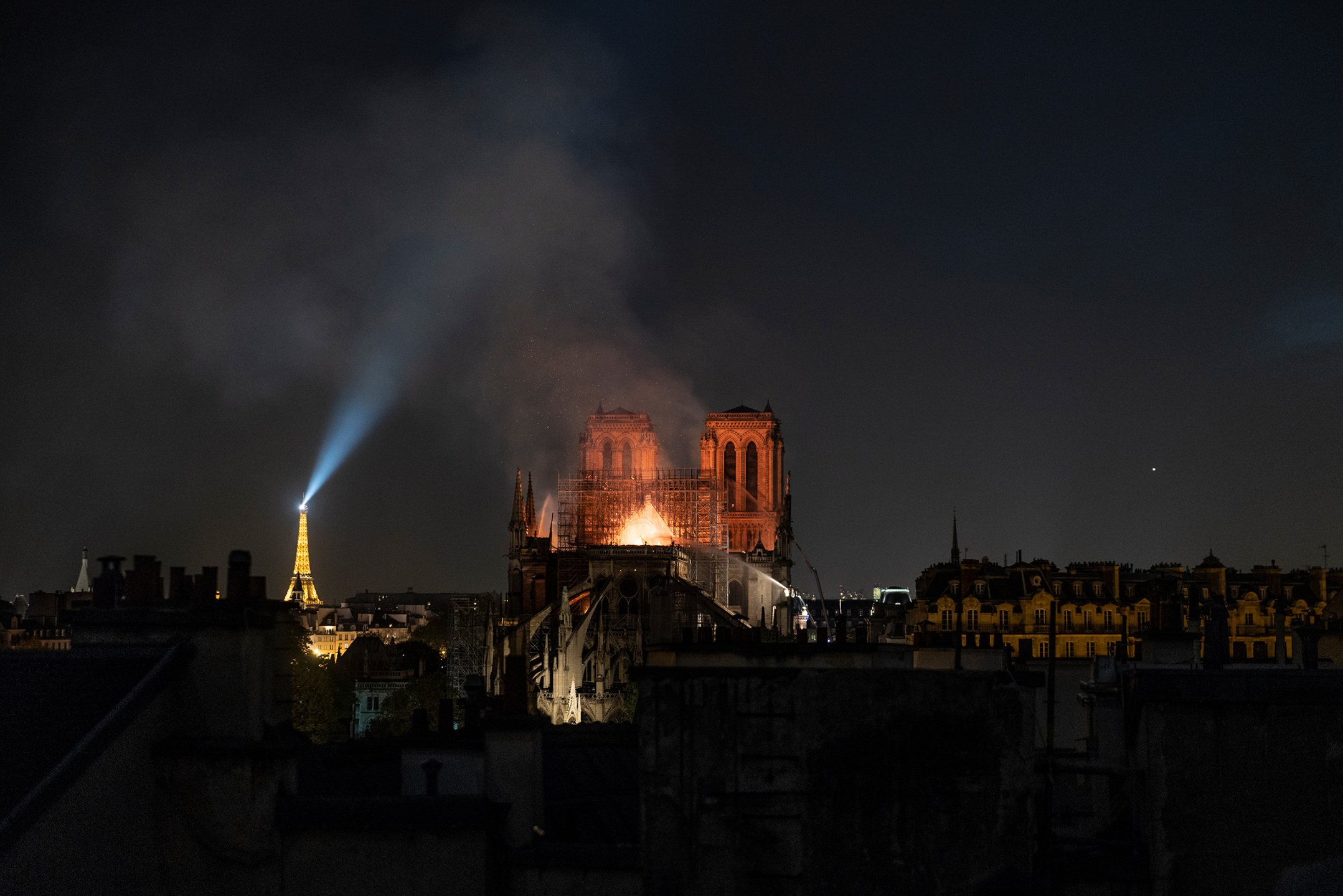 Smoke and flames rise from Notre Dame in Paris on April 15. The city was in flames months before the blaze at the cathedral. Protesters enraged over President Emmanuel Macron's economic plans had smashed storefronts and vandalized ATMs. But the smoke that filled the sky that day seemed to give the beleaguered city a sense of unity. Soon, another took hold: how to rebuild?