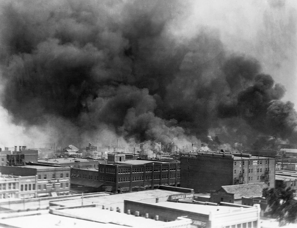 Black smoke billows from fires during the race riot of 1921 in Tulsa, Oklahoma.— (Corbis/Getty Images)