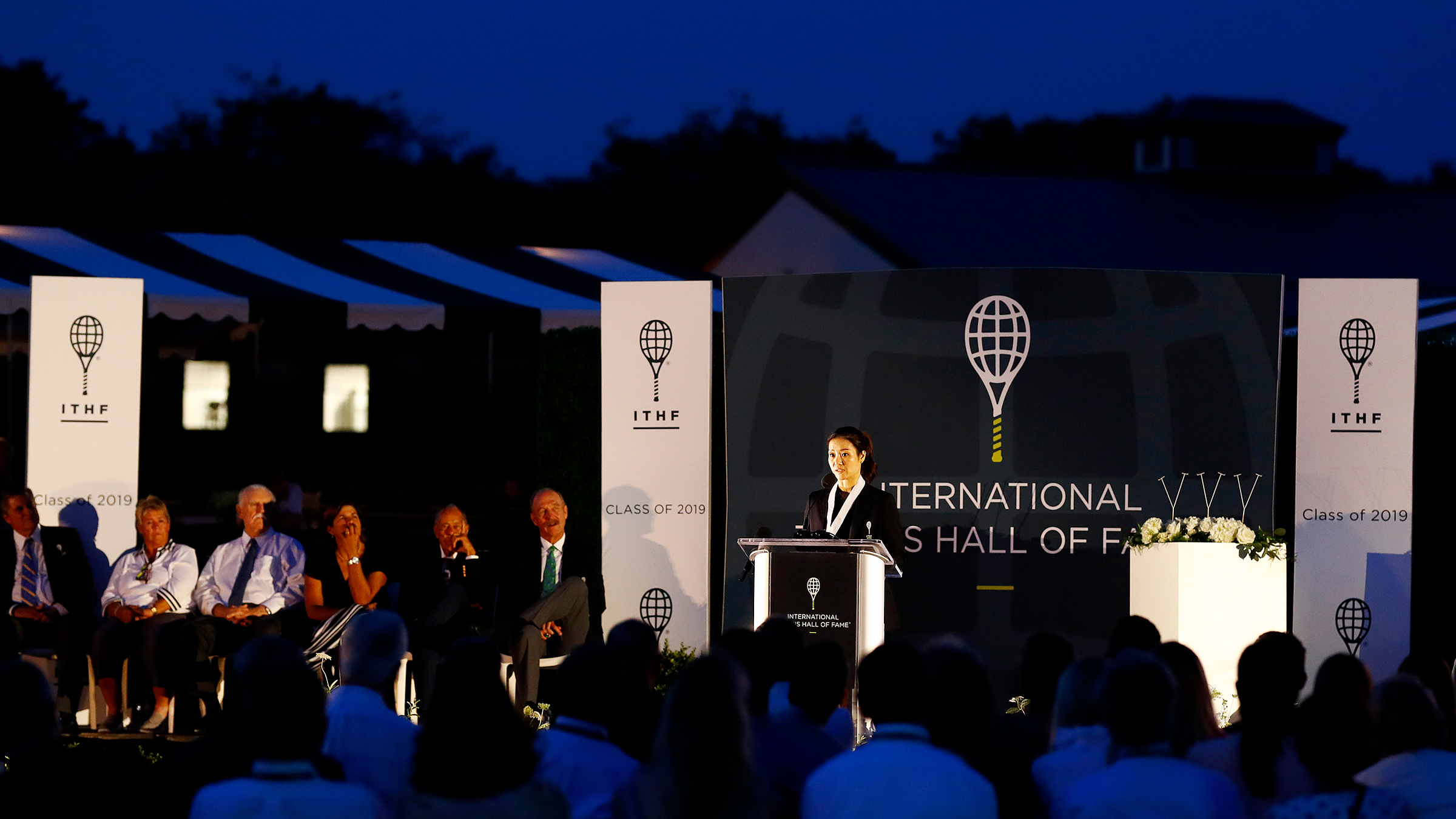 Li Na gives her speech after being inducted into the International Tennis Hall of Fame in Newport, Rhode Island on July 20, 2019. (Omar Rawlings— International Tennis Hall of Fame/Getty Images)