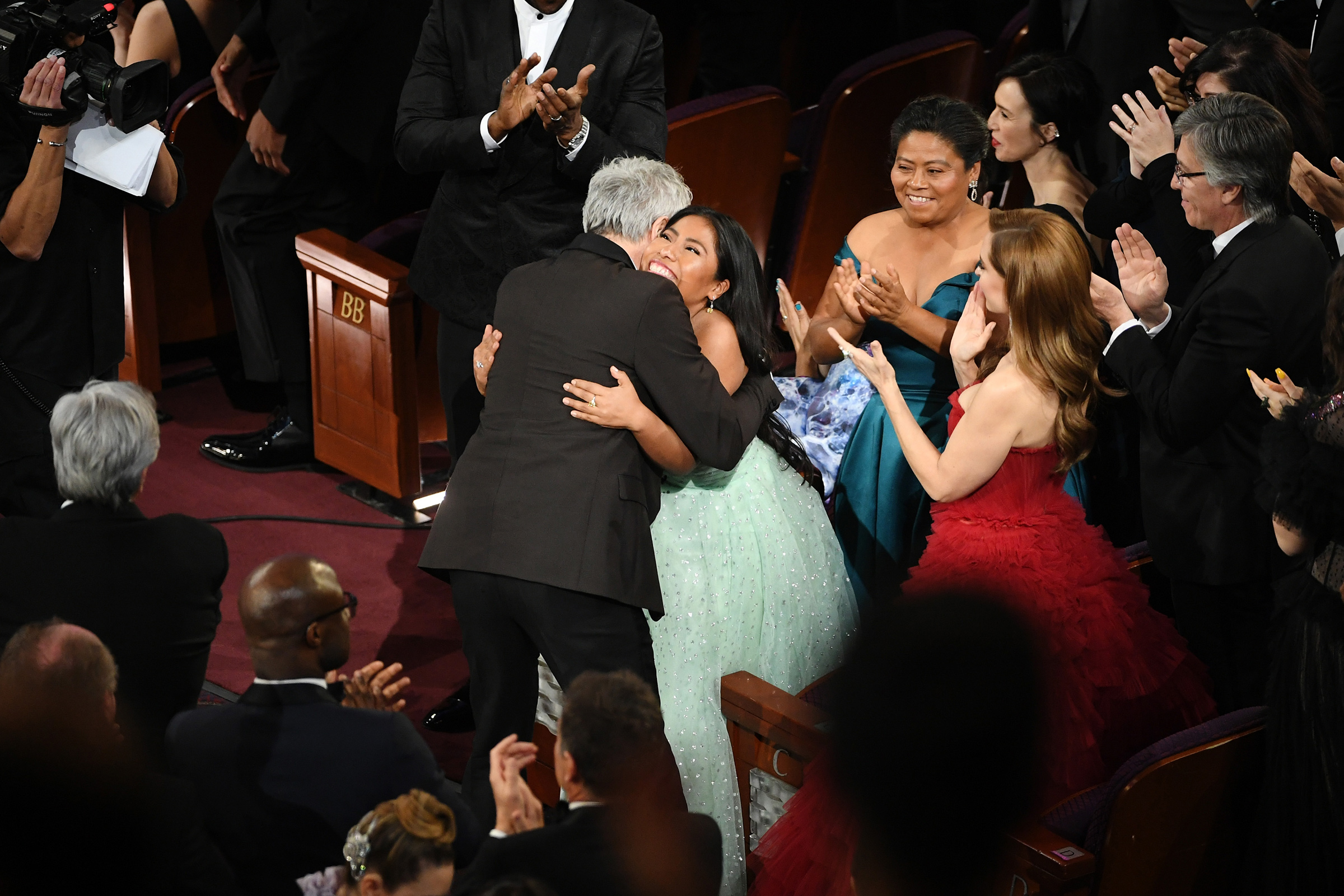 Yalitza Aparicio hugs Alfonso Cuaron after Cuaron won the Cinematography award for 'Roma' during the 91st Annual Academy Awards on Feb. 24, 2019.