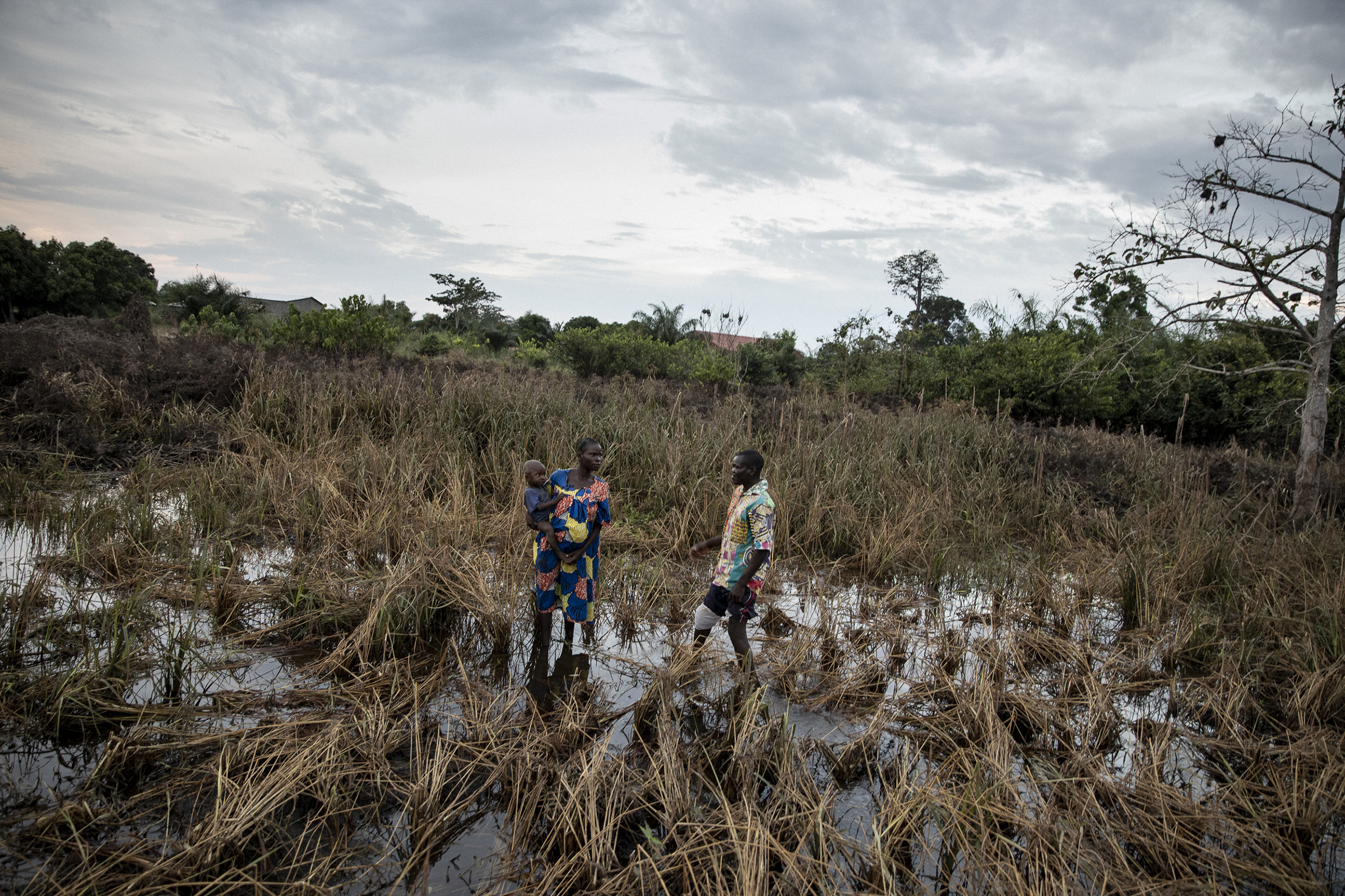 A neighbor and Locadie Lapenda, a 30-year old mother of four stand in her flooded rice field on Nov. 24, 2019. (Adrienne Surprenant—Greenpeace)